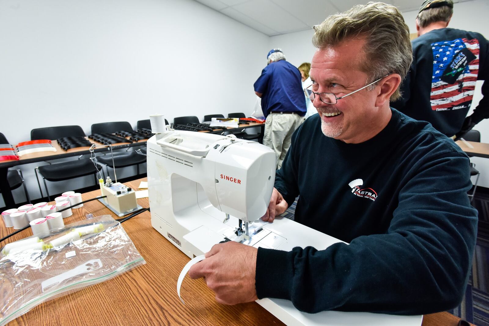 Kevin Dubas sews an elasitc headband as his fellow Team Fastrax members and a few other volunteers helped print, cut and sew to make face shields for Atrium Medical Center employees Thursday, April 10, 2020 in Middletown. The forehead bands were printed on a 3d printer, shields were cut out and elastic bands were sewn to make the masks. NICK GRAHAM / STAFF