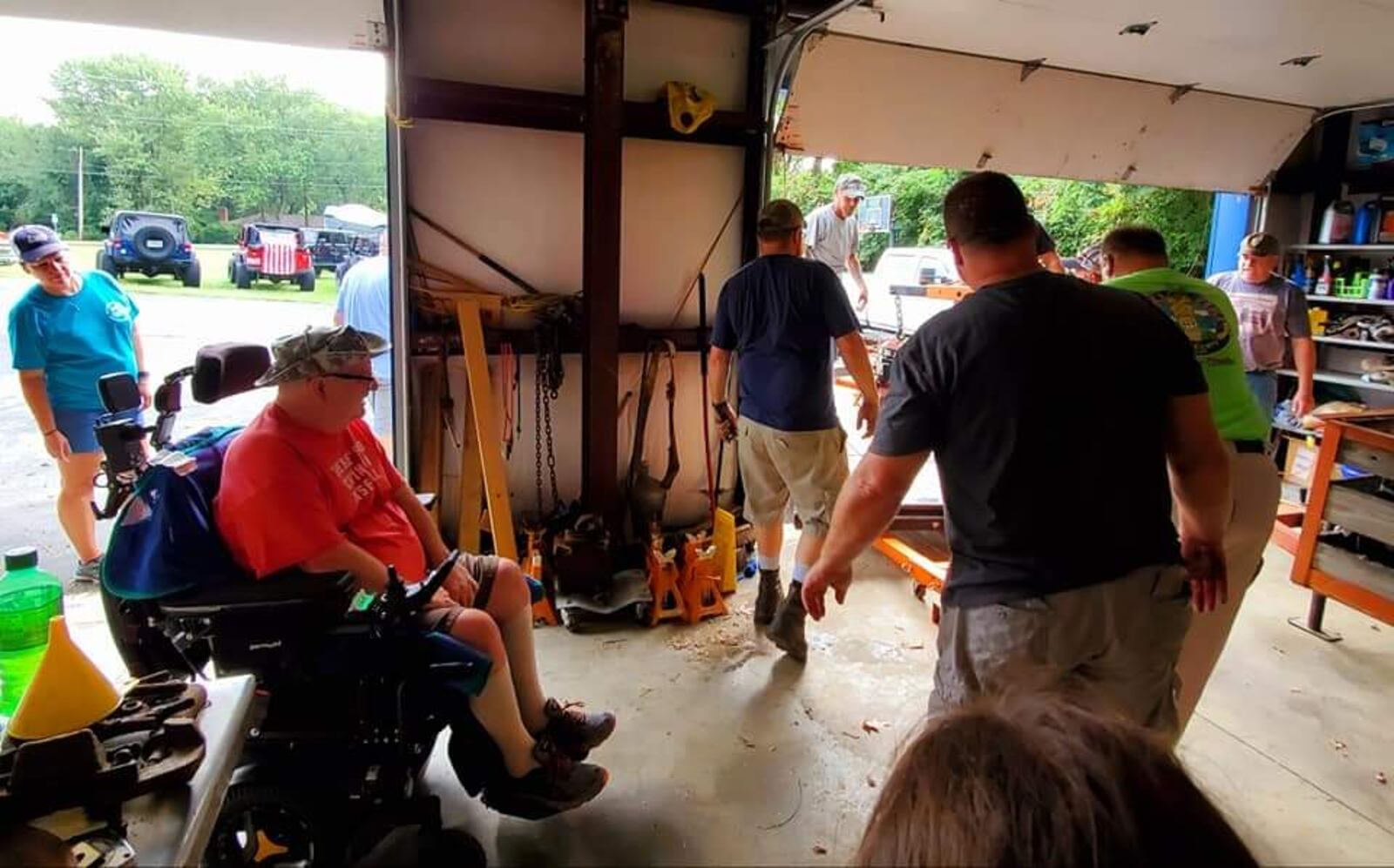 Members of the Middletown Area Jeepers Club remove Jeep parts out of the garage of a man with ALS. The members and others plan to rebuild the Jeep for Bill Hammock. SUBMITTED PHOTO