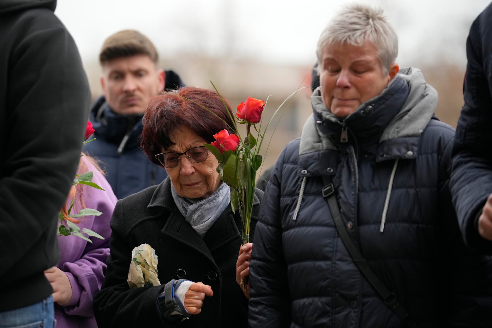 Citizens pay tribute to deaths outside St. John's Church near a Christmas Market, where a car drove into a crowd on Friday evening, in Magdeburg, Germany, Saturday, Dec. 21, 2024. (AP Photo/Ebrahim Noorozi)