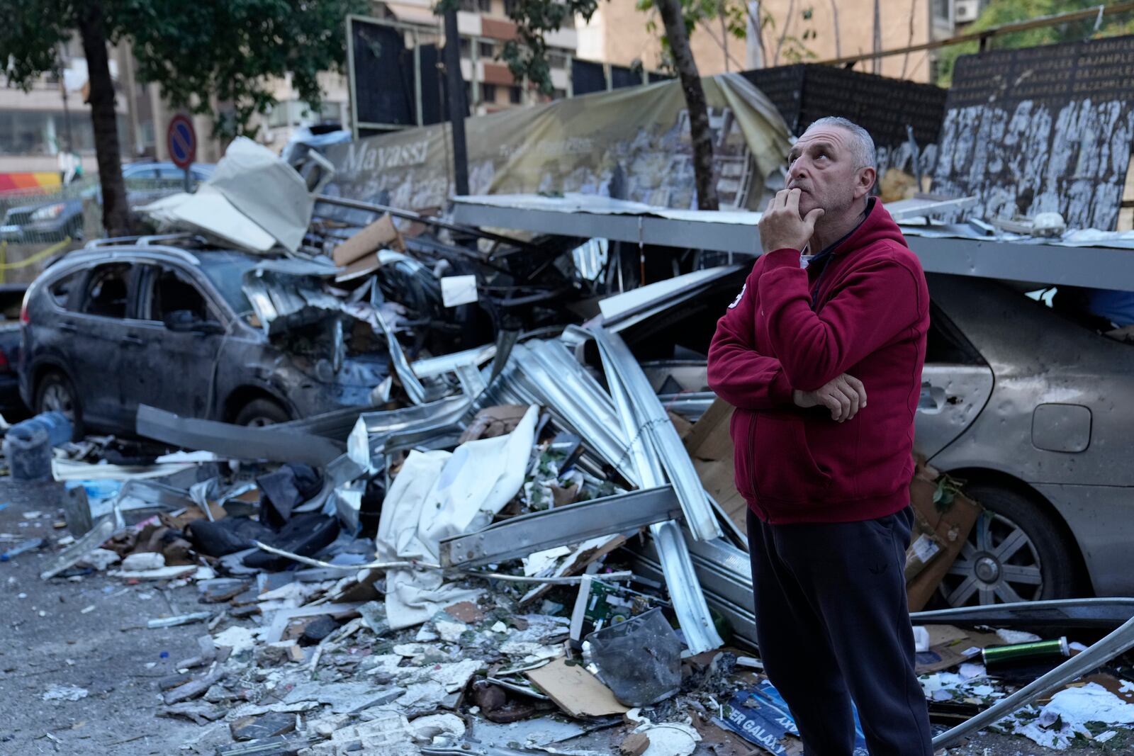 A man watches the damage at the site where an Israeli airstrike Sunday evening hit in central Beirut, Lebanon, Monday, Nov. 18, 2024. (AP Photo/Hussein Malla)