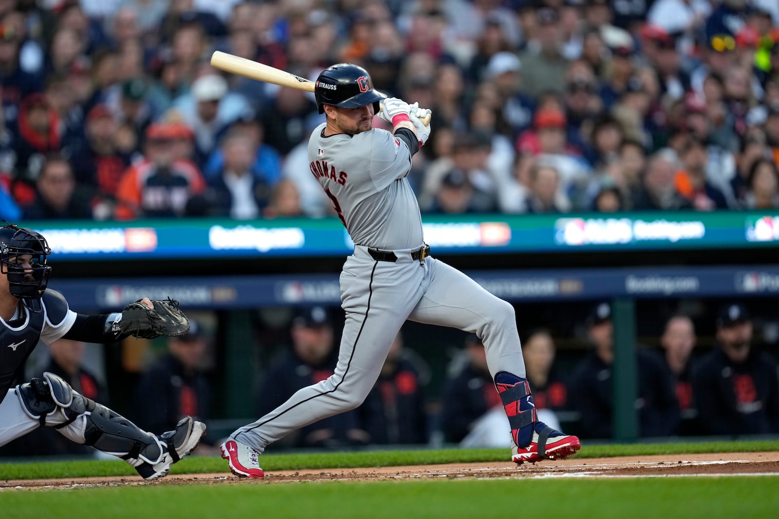 Cleveland Guardians' Lane Thomas hits an RBI single to score teammate Steven Kwan in the first inning during Game 4 of a baseball American League Division Series against the Detroit Tigers, Thursday, Oct. 10, 2024, in Detroit. (AP Photo/Paul Sancya)