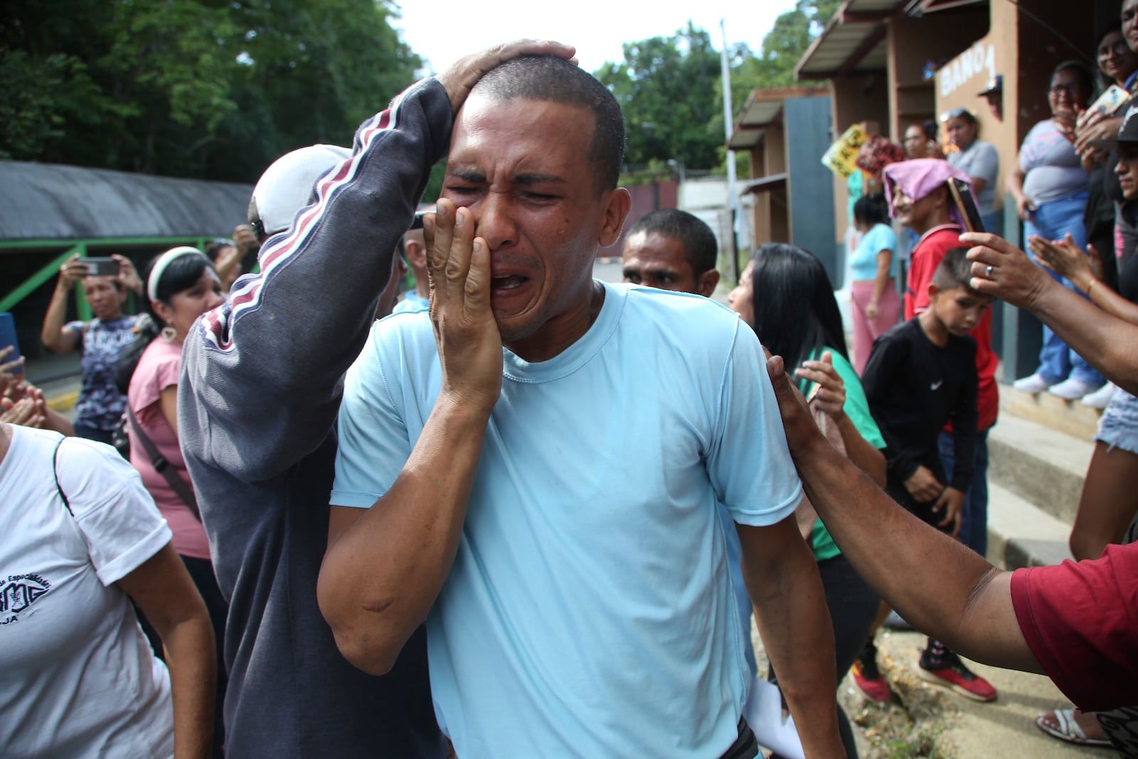 A person who was detained during a government crackdown following anti-government protests against the results of the presidential election, is overcome by emotion upon his release from the Yare 3 prison, in San Francisco de Yare, Venezuela, Saturday, Nov. 16, 2024. (AP Photo/Cristian Hernandez)