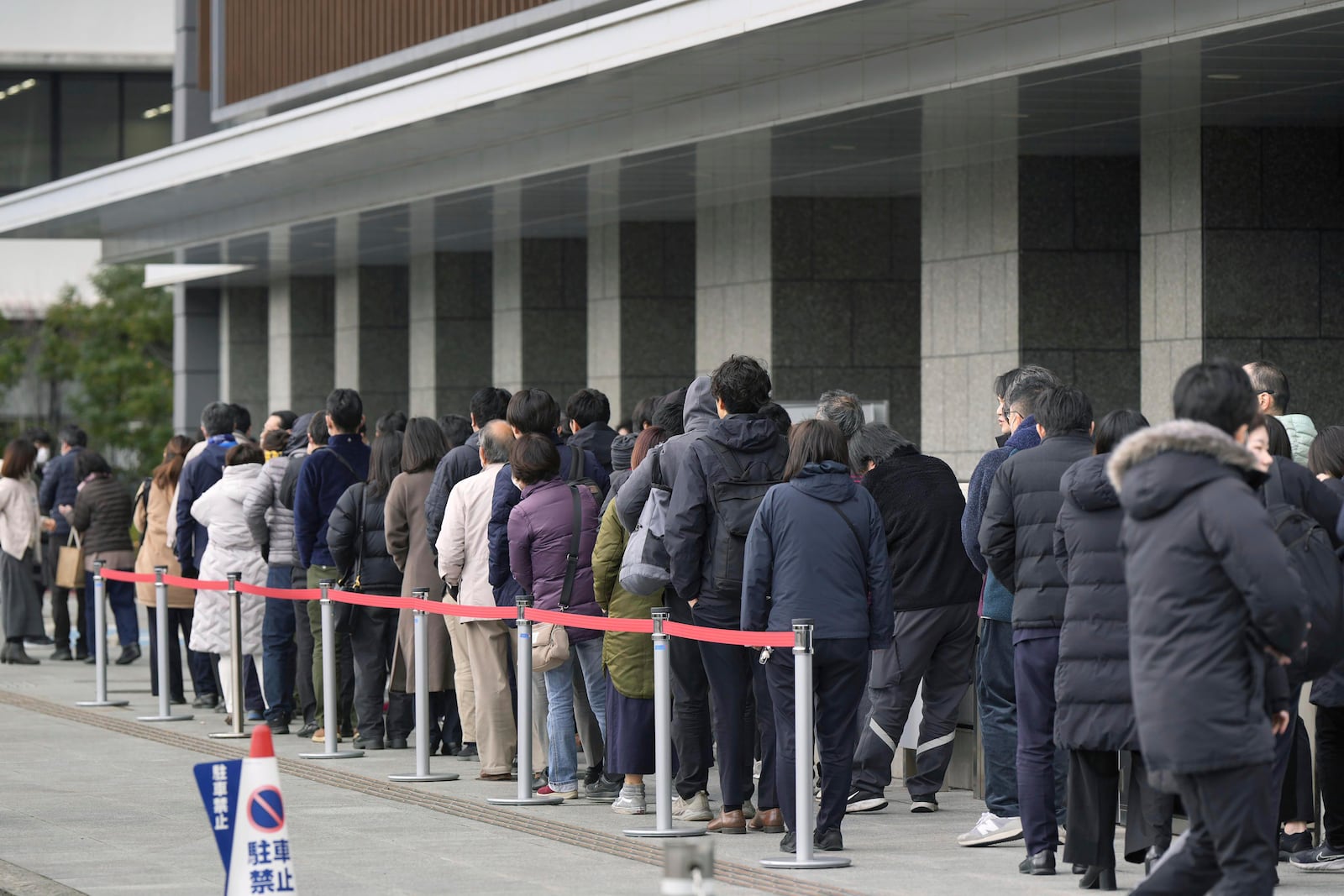 People queue up to get a ticket for a seat to observe a court's ruling on an attempted murder trial for Ryuji Kimura, who threw a homemade pipe bomb at former Japanese Prime Minister Fumio Kishida at a 2023 campaign event, outside Wakayama District Court in Wakayama, western Japan Wednesday, Feb. 19, 2025. (Shohei Miyano/Kyodo News via AP)