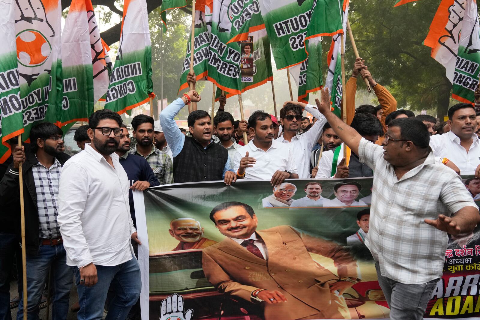 India's opposition Congress party members shout slogans during a protest against Indian billionaire Gautam Adani and Indian Prime Minister Narendra Modi after Adani was indicted by U.S. prosecutors for bribery and fraud, in New Delhi, India, Monday, Nov. 25, 2024. (AP Photo/Manish Swarup)