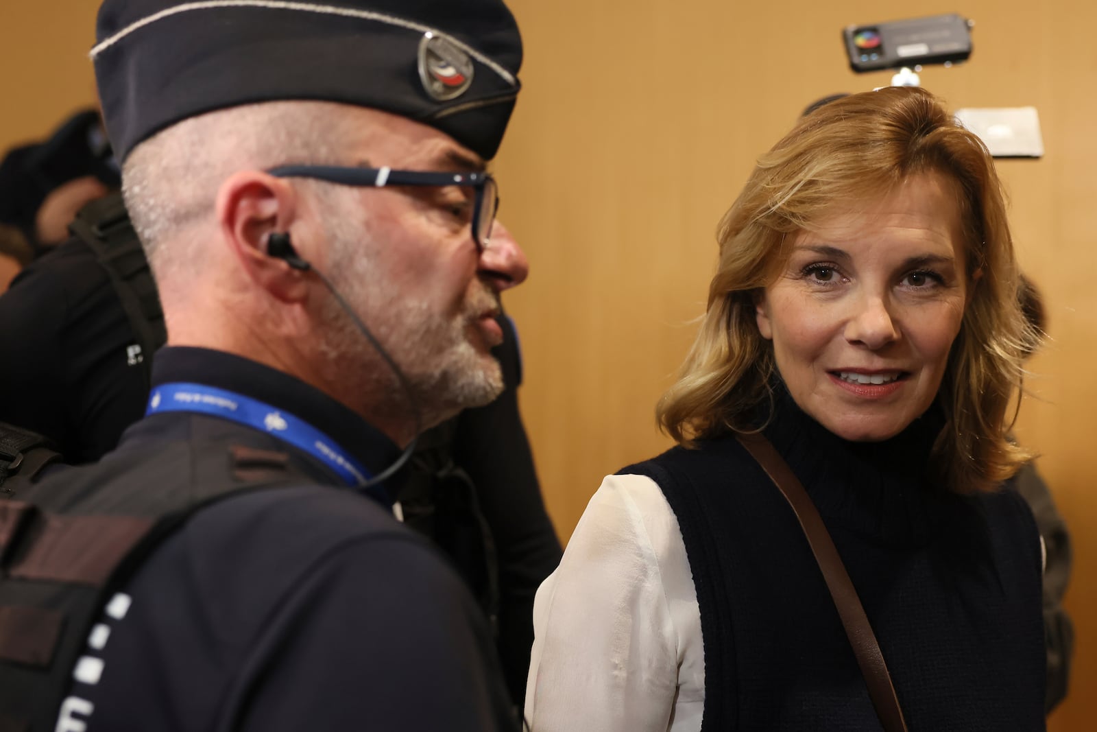 Plaintiff Amélie Kyndt leaves the courtroom, while actor Gerard Depardieu, who is facing trial for the alleged sexual assaults of two women on a film set in 2021, did not appear before a criminal court, Monday, Oct. 28, 2024 in Paris. (AP Photo/Thomas Padilla)