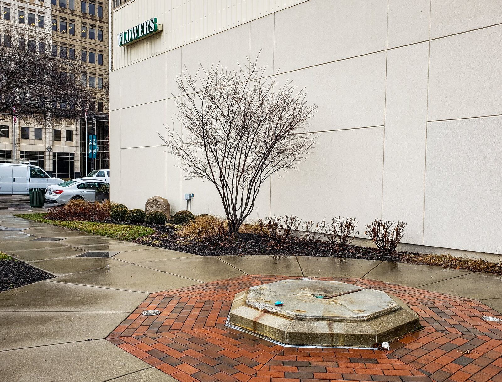 The “Hebe, Nymph of Streams and Brooks” fountain that stood at the corner of High Street and North Martin Luther Kijng Jr. Boulevard in Hamilton was struck and destroyed in October 2019 by a classic 1957 Buick. The base remains where the statue once stood, awaiting its return. NICK GRAHAM/STAFF