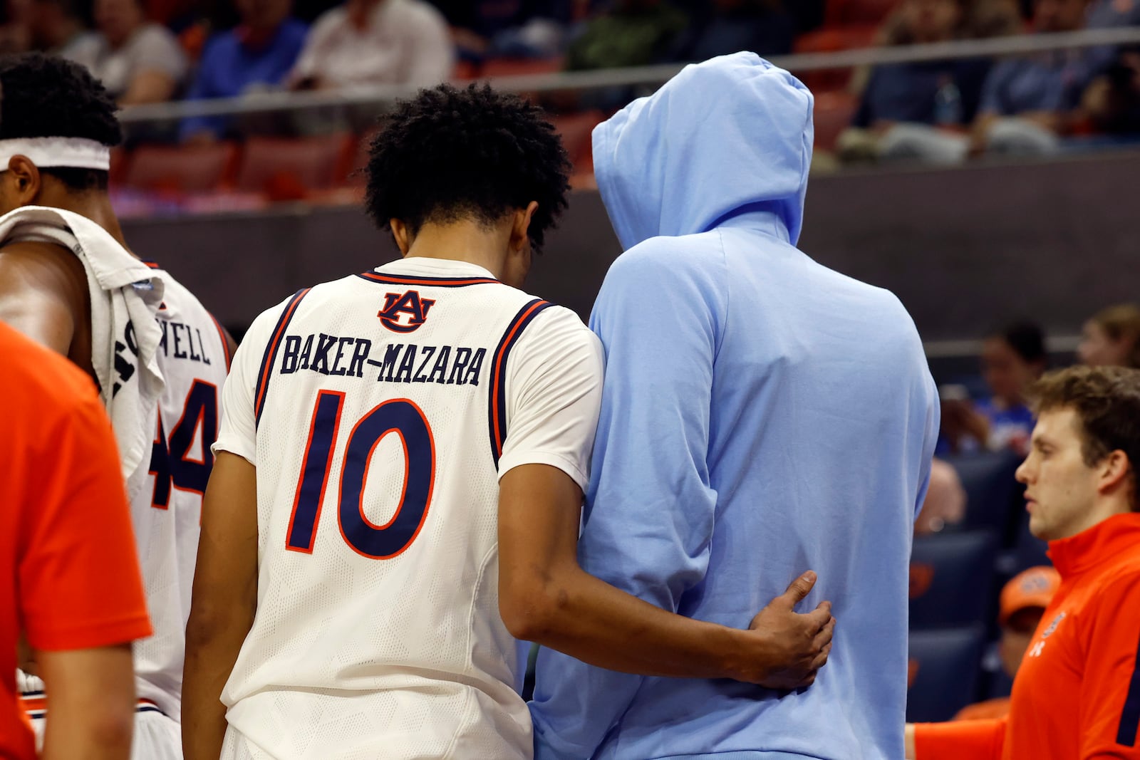 Auburn guard Chad Baker-Mazara (10) consoles teammate forward Johni Broome after he sustained an injury against Georgia State during the first half of an NCAA college basketball game, Tuesday, Dec. 17, 2024, in Auburn, Ala. (AP Photo/ Butch Dill)