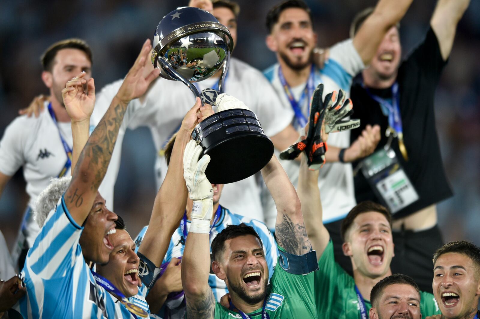 Players of Argentina's Racing Club celebrate with the trophy after winning the Copa Sudamericana final soccer match against Brazil's Cruzeiro in Asuncion, Paraguay, Saturday, Nov. 23, 2024. (AP Photo/Gustavo Garello)