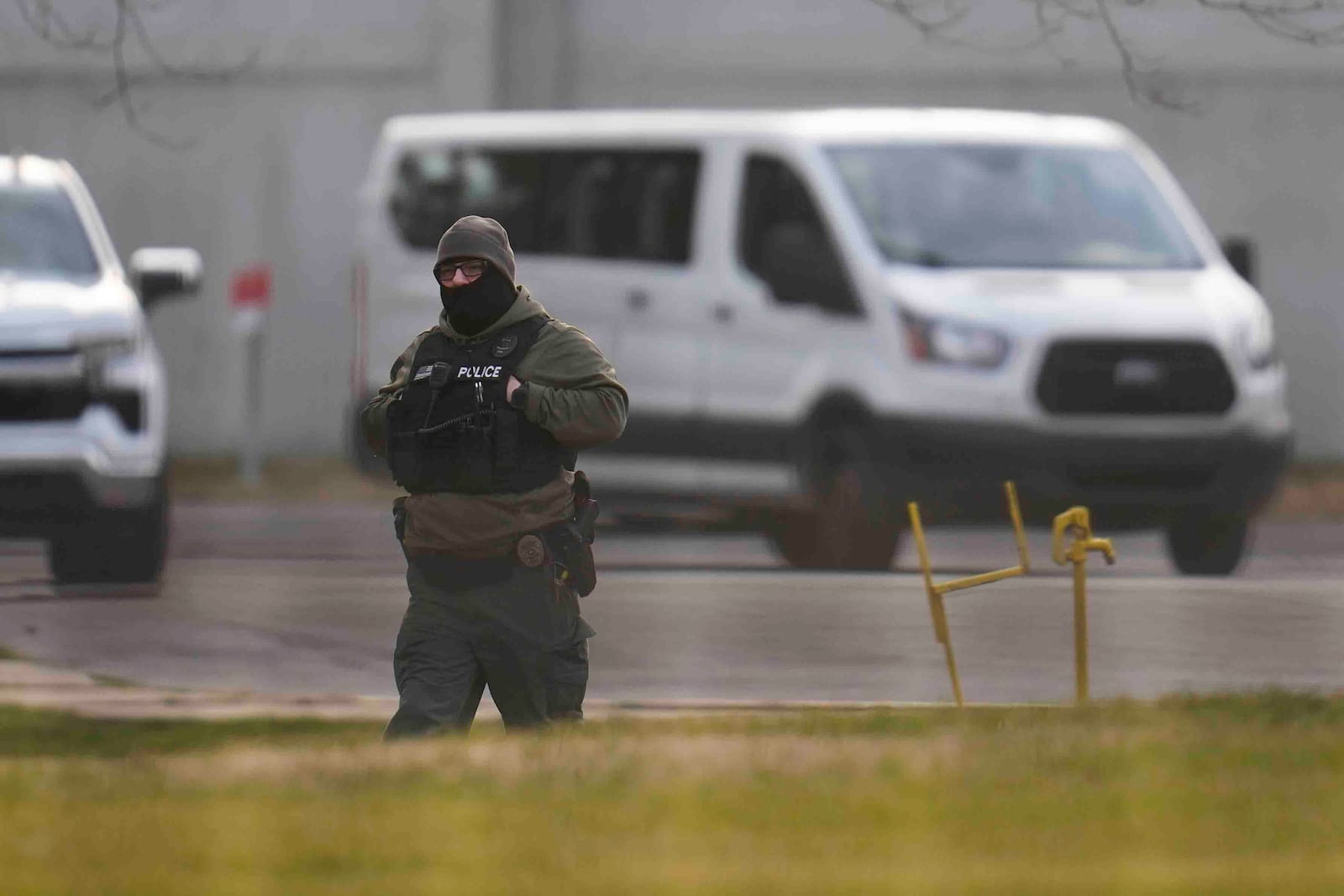 A police officer walks outside of Indiana State Prison where, barring last-minute court action or intervention by Gov. Eric Holcomb, Joseph Corcoran, 49, convicted in the 1997 killings of his brother and three other people, is scheduled to be put to death by lethal injection before sunrise Tuesday, Dec. 17, 2024, in Michigan City, Ind. (AP Photo/Erin Hooley)