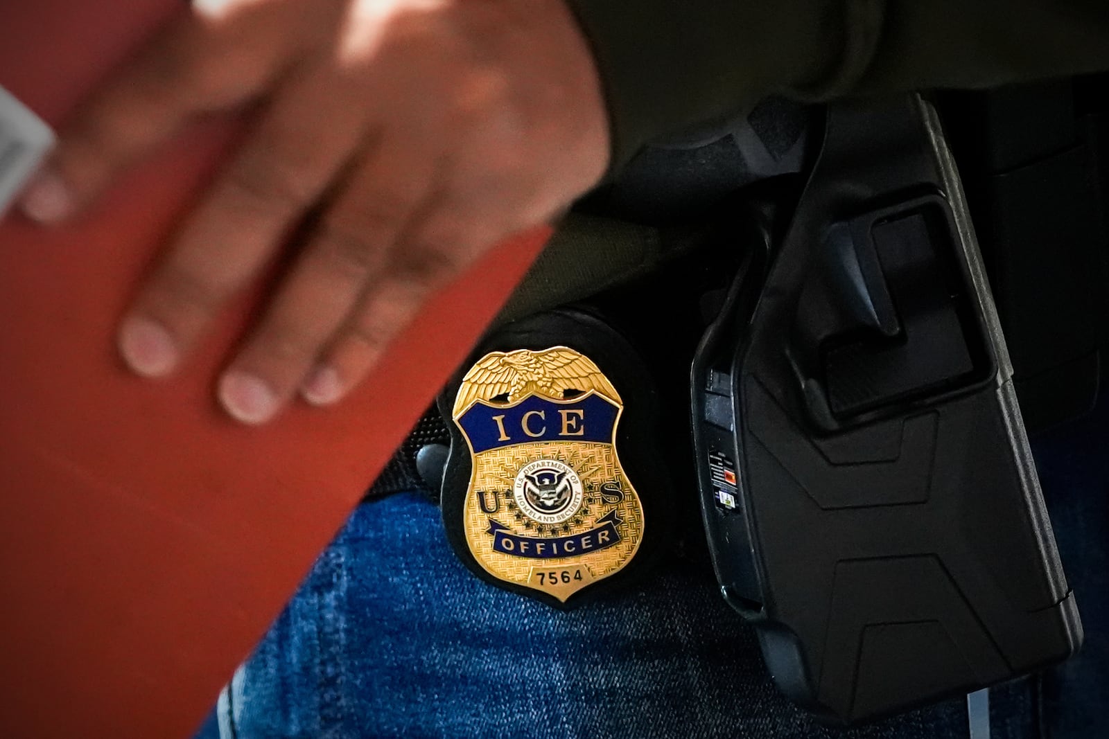 A deportation officer with Enforcement and Removal Operations in U.S. Immigration and Customs Enforcement's New York City field office conducts a brief before an early morning operation, Tuesday, Dec. 17, 2024, in the Bronx borough of New York. (AP Photo/Julia Demaree Nikhinson)