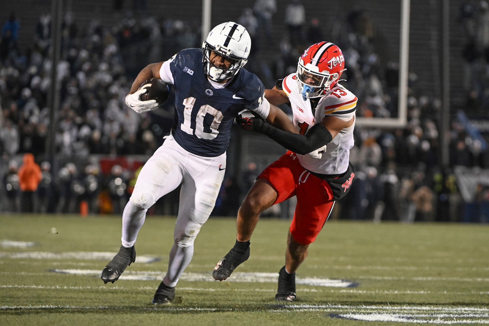 Penn State running back Nicholas Singleton (10) scores a touchdown while being chased by Maryland defensive back Glendon Miller during the fourth quarter of an NCAA college football game, Saturday, Nov. 30, 2024, in State College, Pa. (AP Photo/Barry Reeger)