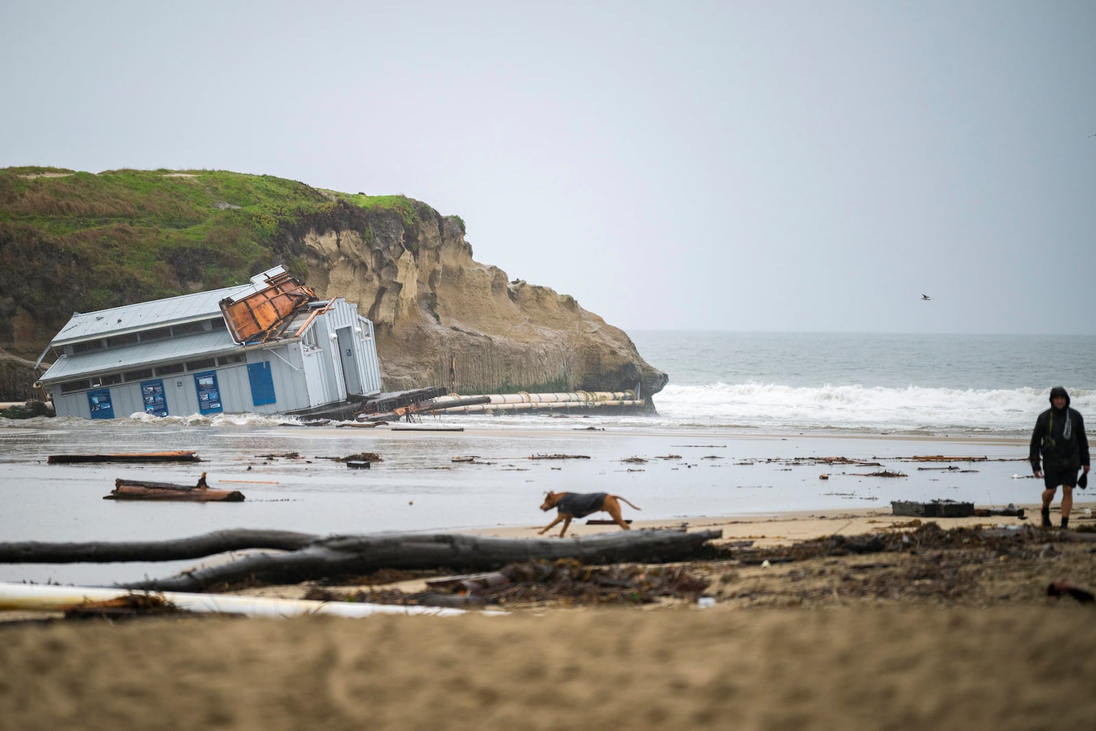 Remnants of a bathroom that fell off the wharf are seen at the mouth of the San Lorenzo River in Santa Cruz, Calif., Tuesday, Dec. 24, 2024. (AP Photo/Nic Coury)