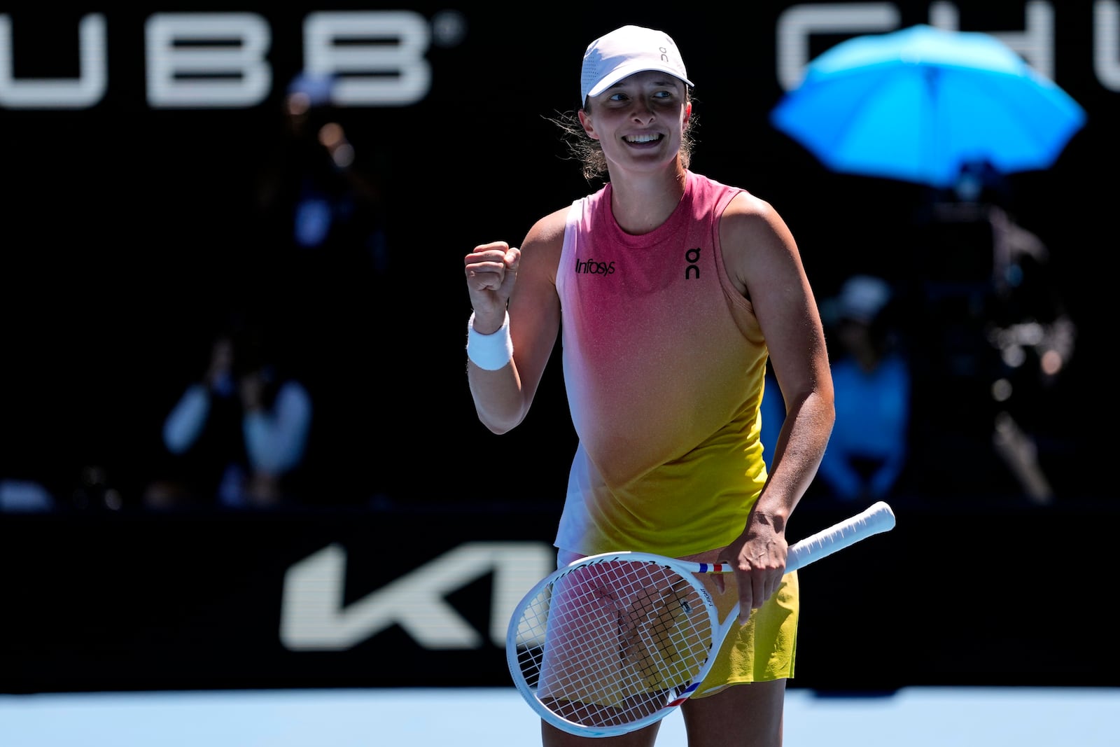 Iga Swiatek of Poland celebrates after defeating Emma Navarro of the U.S. in their quarterfinal match at the Australian Open tennis championship in Melbourne, Australia, Wednesday, Jan. 22, 2025. (AP Photo/Vincent Thian)