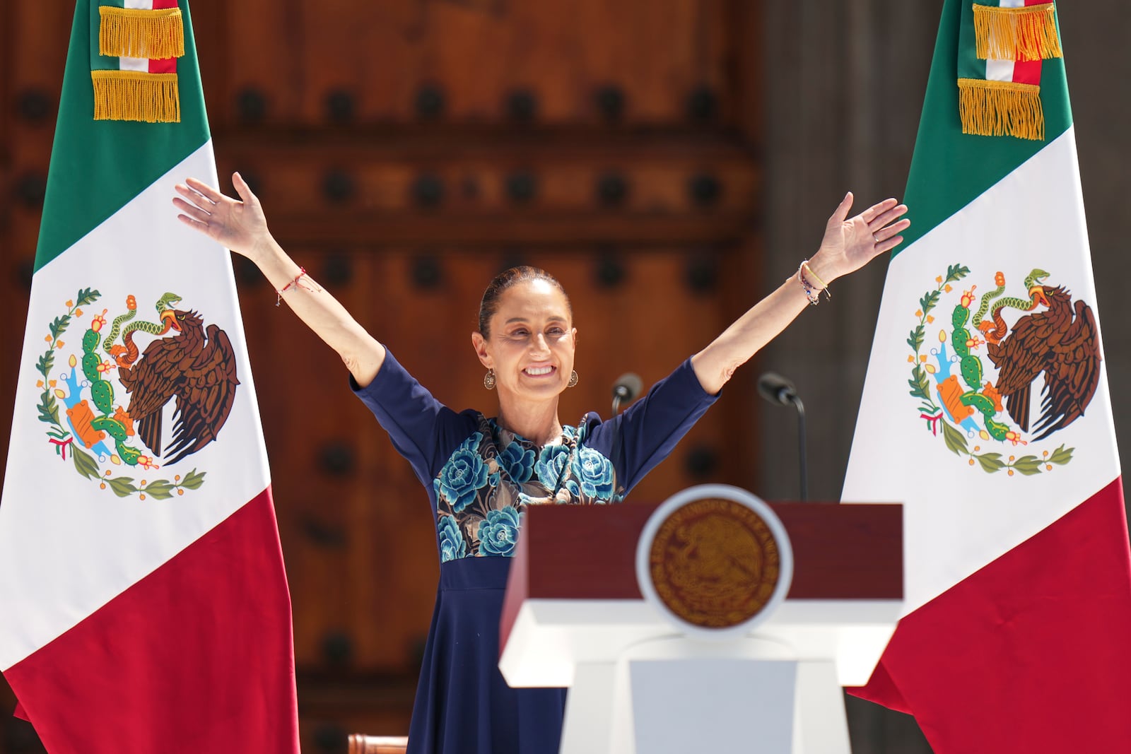 President Claudia Sheinbaum addresses supporters at a rally she convened to welcome U.S. President Donald Trump's decision to postpone tariffs on Mexican goods for one month at the Zocalo, Mexico City's main square, Sunday, March 9, 2025. (AP Photo/Eduardo Verdugo)