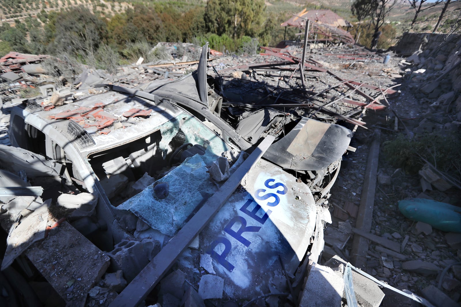 Destroyed vehicles used by journalists at the site where an Israeli airstrike hit a compound housing journalists, killing three media staffers from two different news agencies according to Lebanon's state-run National News Agency, in Hasbaya village, southeast Lebanon, Friday, Oct. 25, 2024. (AP Photo/Mohammed Zaatari)