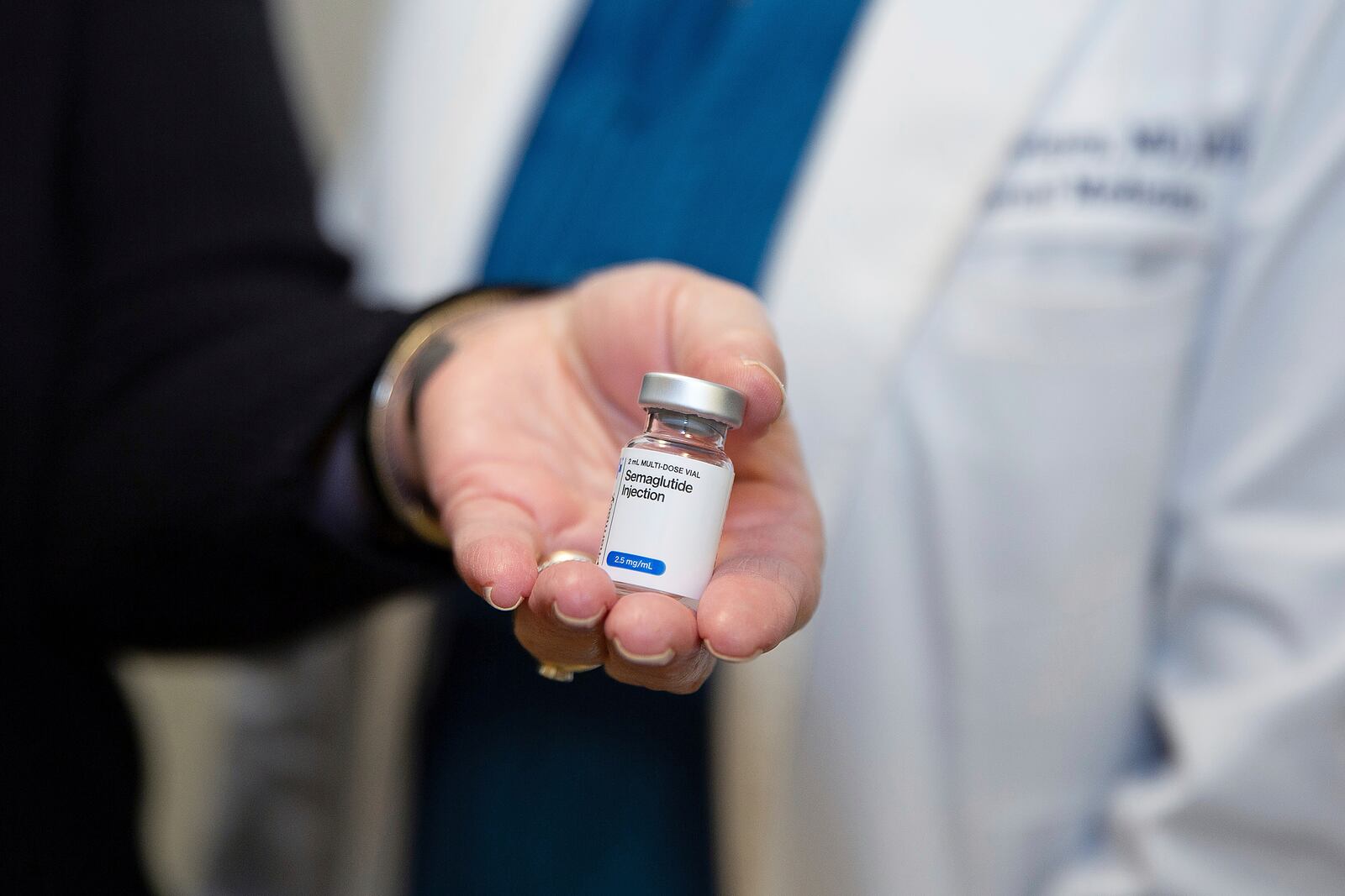 Patient Lory Osborn (left) holds Semaglutide used in replacement of her Wegovy treatment with Dr. Laura Davisson, director of the Medical Weight Management at West Virginia University in Morgantown, W.Va., Monday, Dec. 2, 2024. (AP Photo/Kathleen Batten)