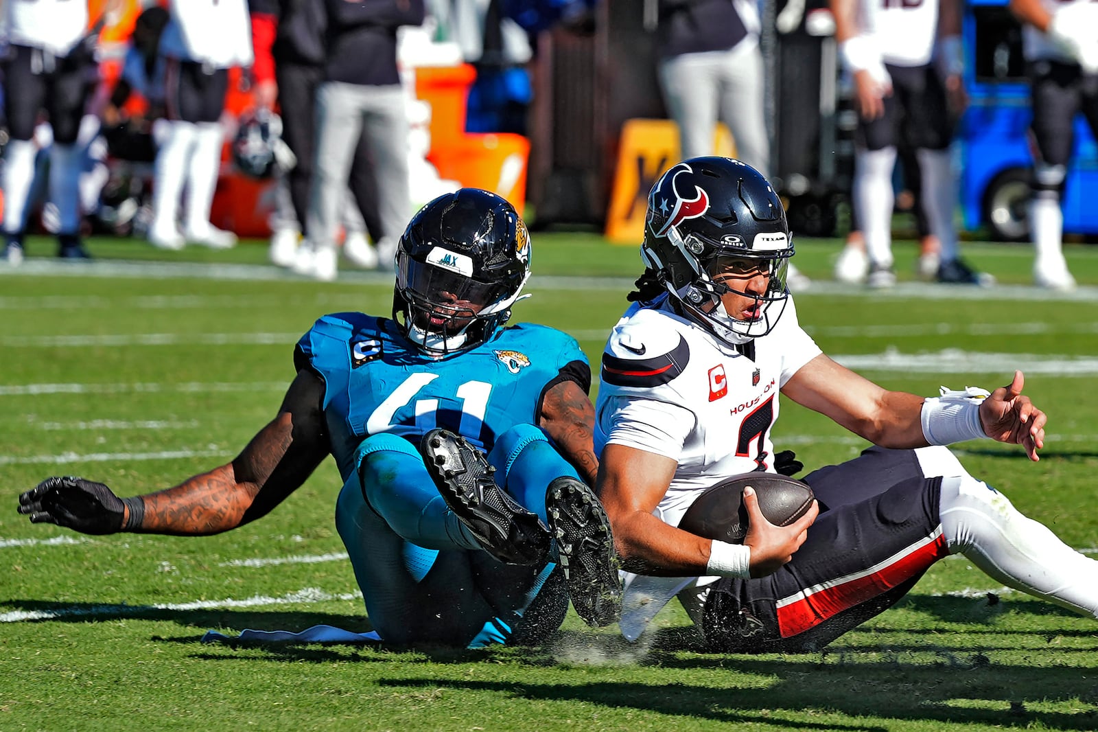 Jacksonville Jaguars defensive end Josh Hines-Allen (41) sacks Houston Texans quarterback C.J. Stroud (7) during the first half of an NFL football game Sunday, Dec. 1, 2024, in Jacksonville, Fla. (AP Photo/John Raoux)