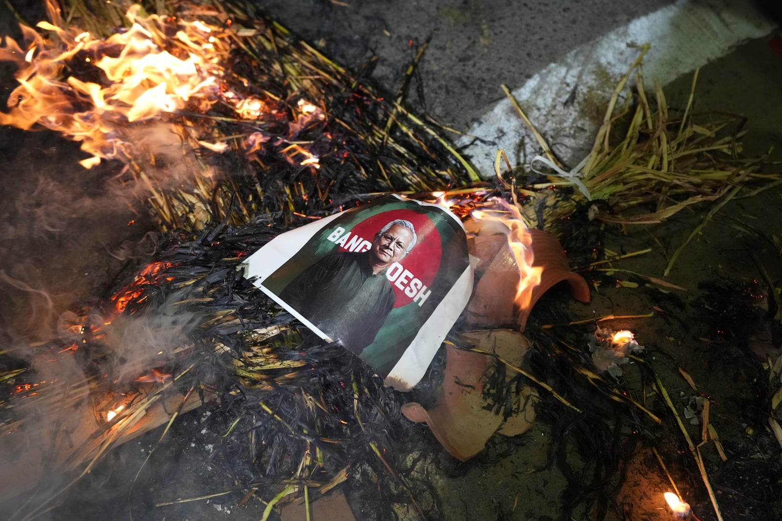 Activists of Bajarang dal, a Hindu rights group, burn an effigy of Bangladesh's interim leader Muhammad Yunus, during a protest against the alleged attacks on Hindus in Bangladesh, in Ahmedabad, India, Wednesday, Dec. 11, 2024. (AP Photo/Ajit Solanki)