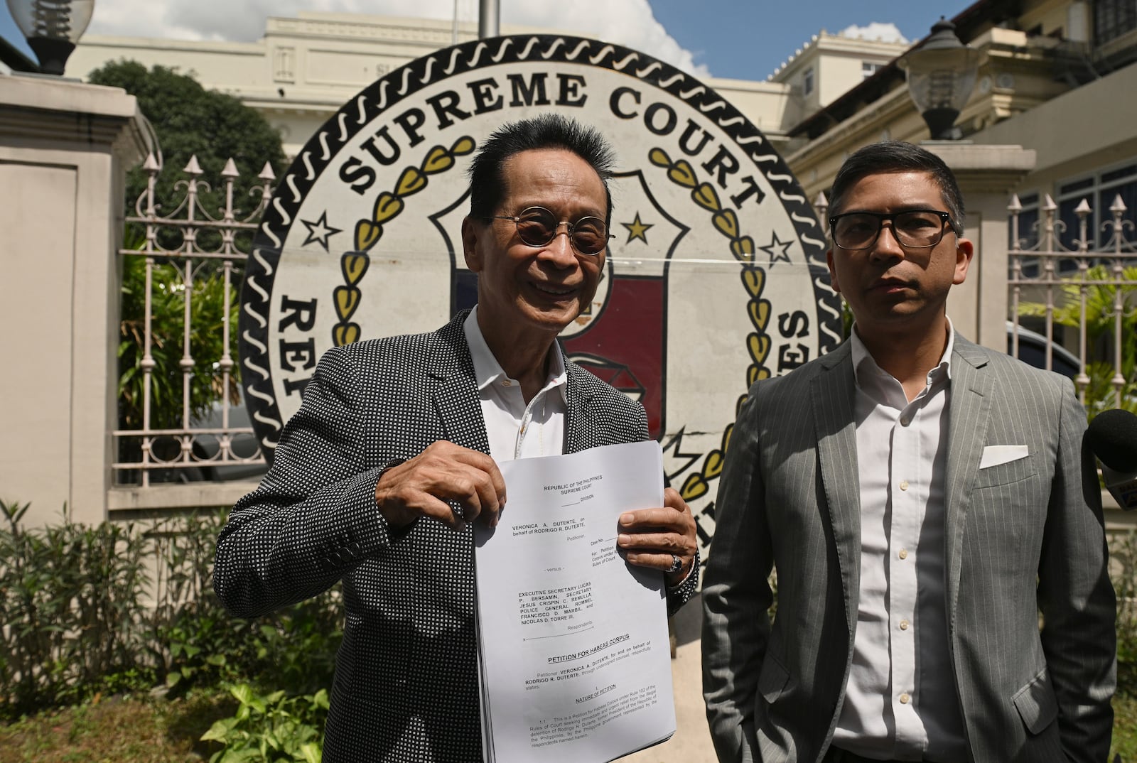 Salvador Panelo, former presidential spokesman and chief presidential legal counsel of Philippine former President Rodrigo Duterte, shows a copy of the Habeas Corpus petition before filing it at the Supreme Court on Wednesday, March 11, 2025 in Manila, Philippines (AP Photo/Noel Celis)