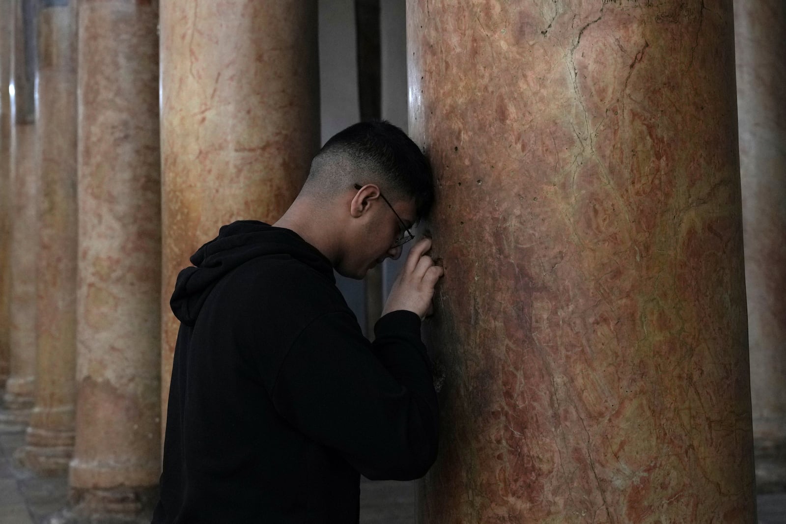 A worshipper visits the Church of the Nativity, where Christians believe Jesus Christ was born, ahead of Christmas in the West Bank city of Bethlehem, Tuesday, Dec. 17, 2024. (AP Photo/Mahmoud Illean)