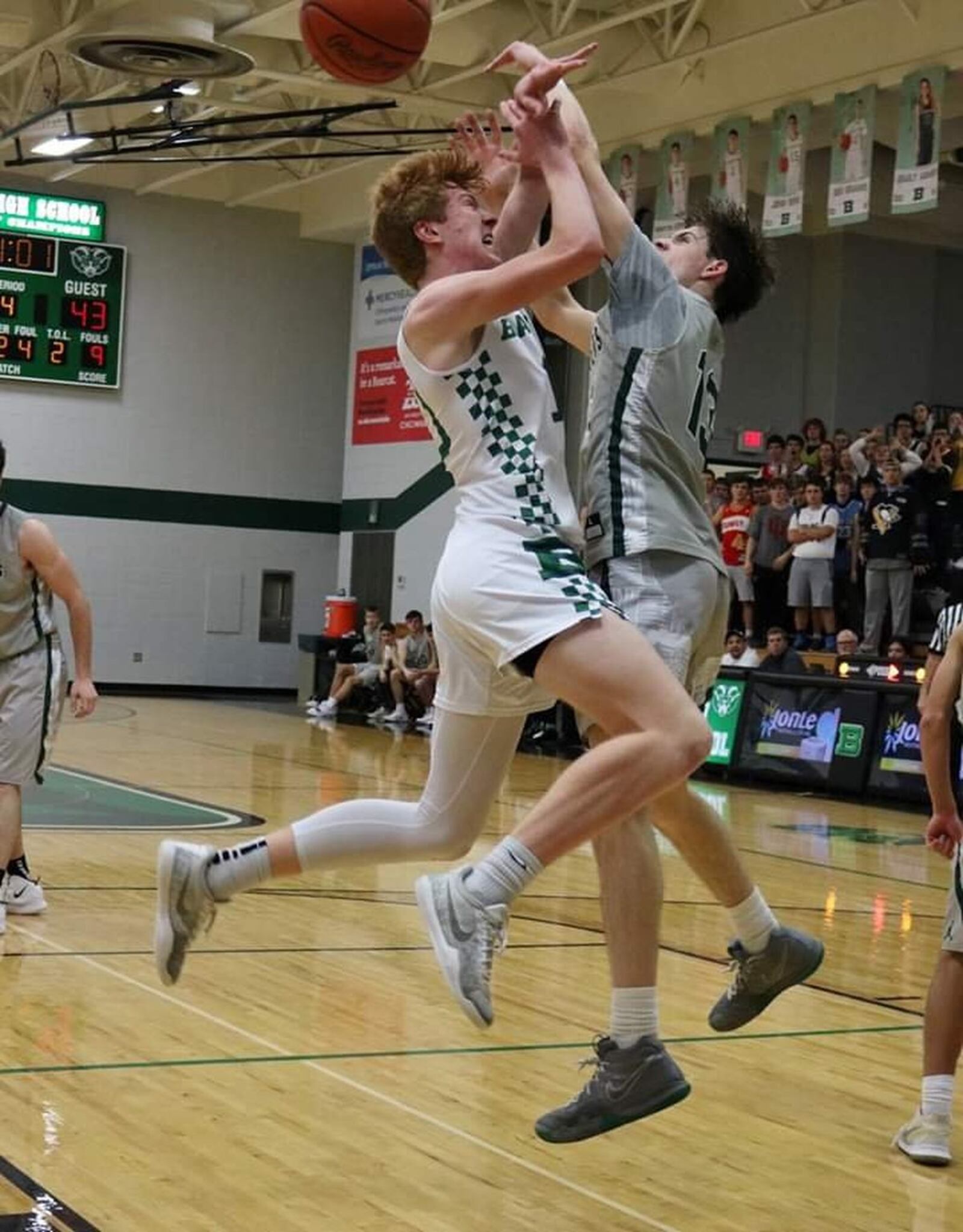 Badin’s Zach Switzer (left) and Evan Brunot of McNicholas clash on a shot attempt Friday night at Mulcahey Gym in Hamilton. McNick won 47-45. CONTRIBUTED PHOTO BY TERRI ADAMS