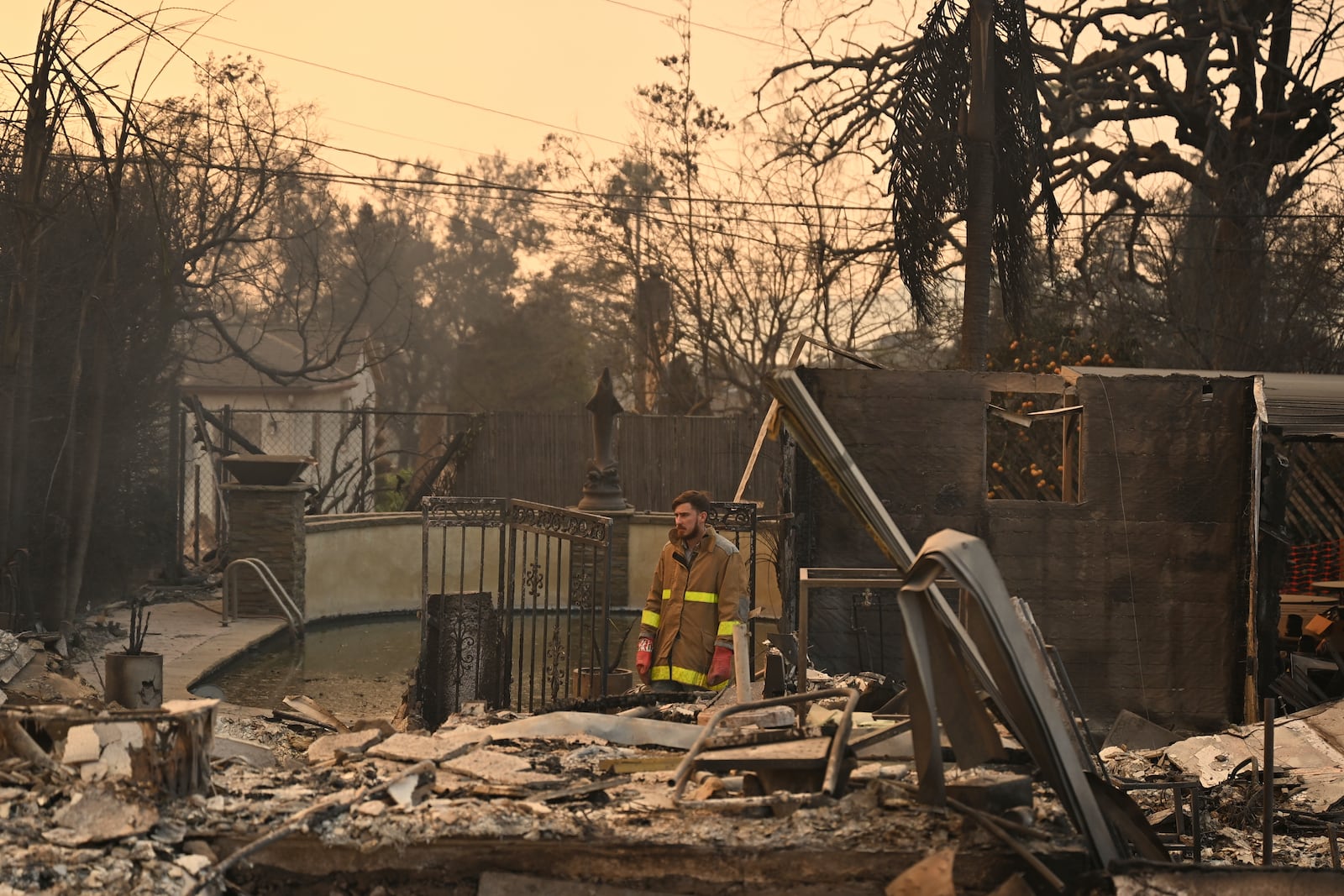 Robert Lara looks through his home that was destroyed after the Eaton Fire burns in Altadena, Calif., Thursday, Jan. 9, 2025. (AP Photo/Nic Coury)