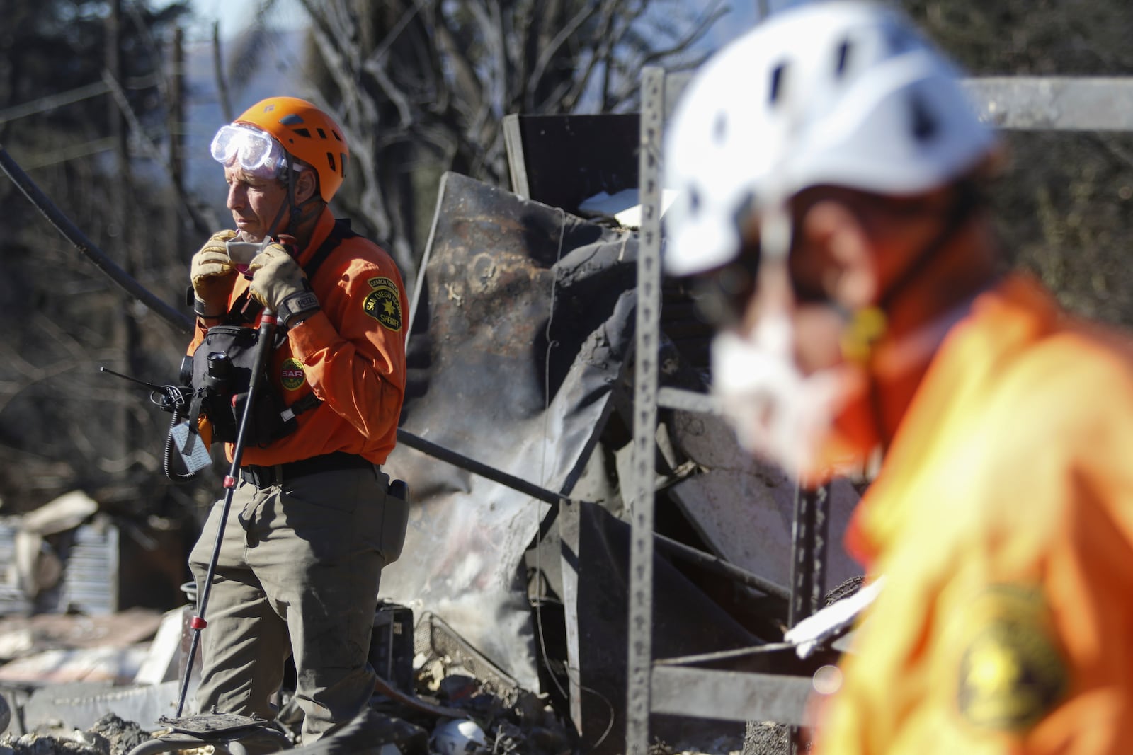 Search and rescue workers dig through the rubble left behind by the Eaton Fire, in Altadena, Calif., Tuesday, Jan. 14, 2025. (AP Photo/Ty O'Neil)