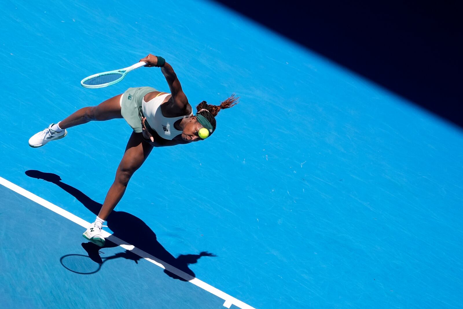 Coco Gauff of the U.S. serves to Paula Badosa of Spain during their quarterfinal match at the Australian Open tennis championship in Melbourne, Australia, Tuesday, Jan. 21, 2025. (AP Photo/Asanka Brendon Ratnayake)