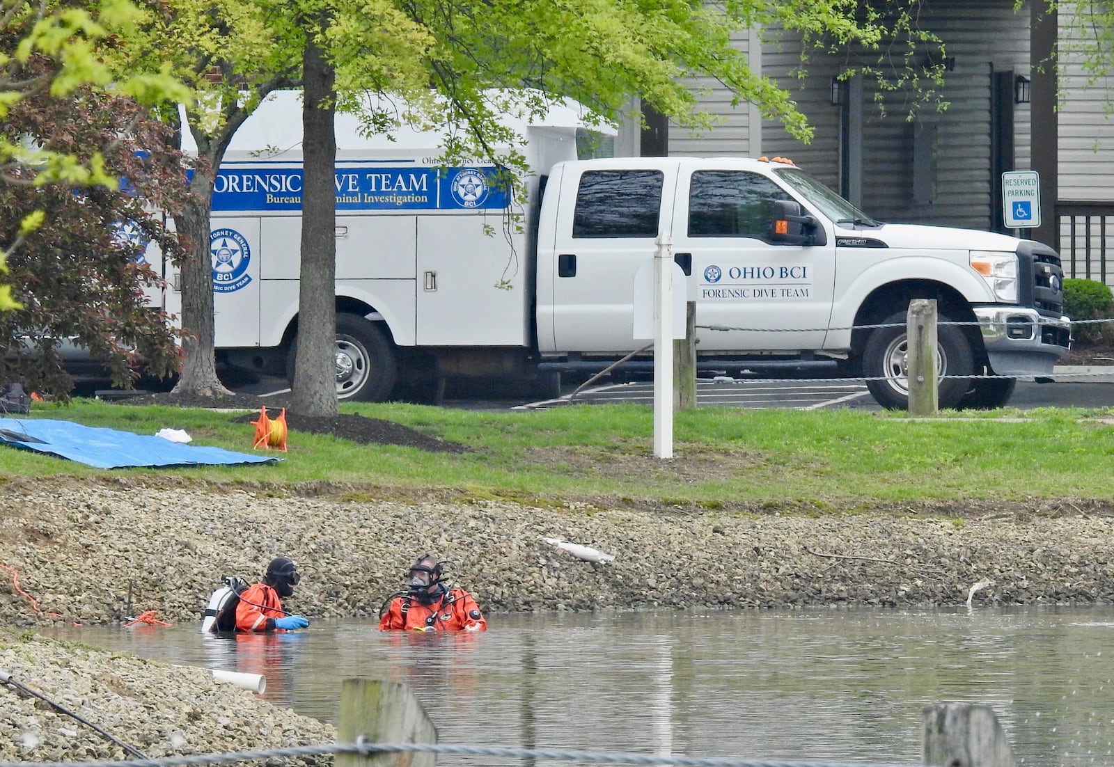 Crews searched a pond at the Lakefront at West Chester apartments on April 30, 2019, after the shooting deaths of four family members in an apartment there. NICK GRAHAM / STAFF