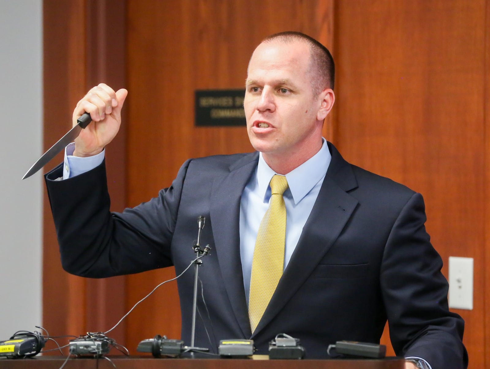 Hamilton Police Chief Craig Bucheit demonstrates how officer Steven McFall was confronted by Michael Wilson-Salzl with a knife before he fired and killed Wilson-Salzl in the parking lot of Knollwood Crossing apartments on Saturday, Apr. 9. GREG LYNCH / STAFF