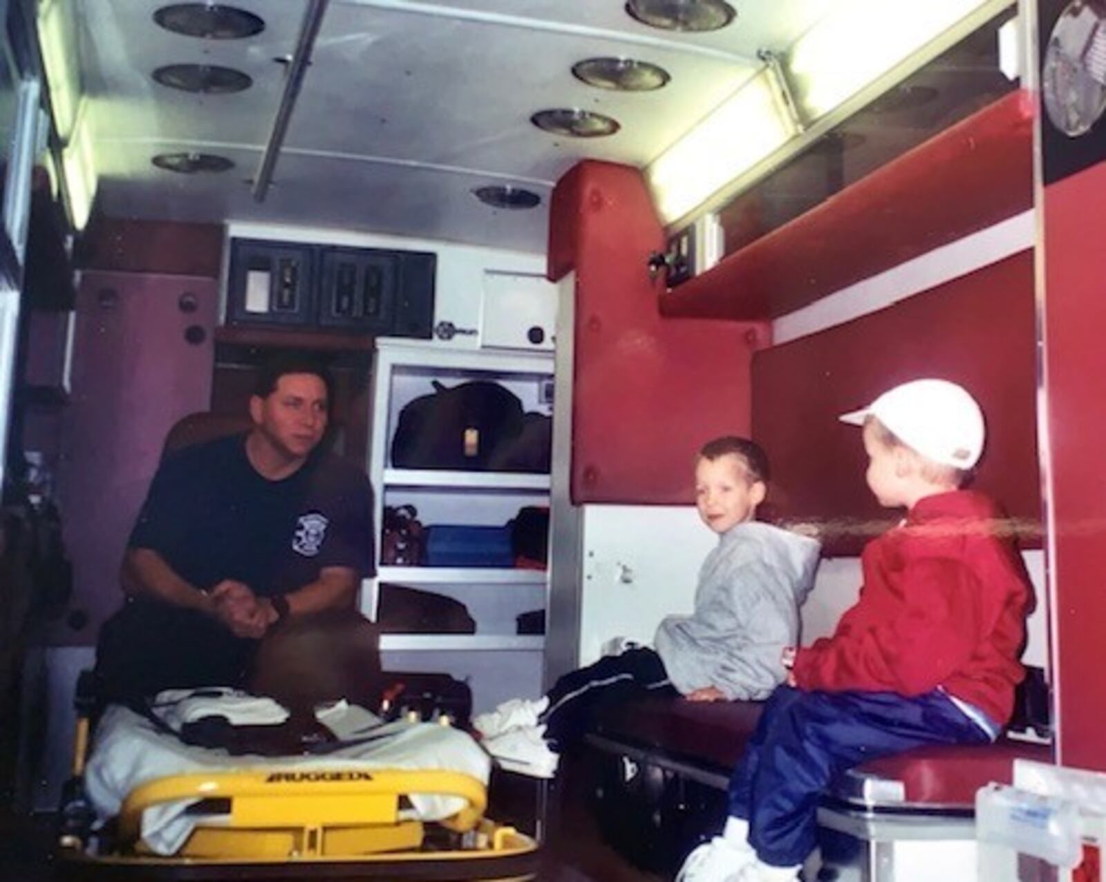 Lt. Paul Lolli talks to Jacob Lentz and his younger brother, Josh, in the back of a Middletown Division of Fire medic unit about 20 years ago. The Lentz brothers now are Middletown firefighters/paramedics and Lolli is fire chief. SUBMITTED PHOTO