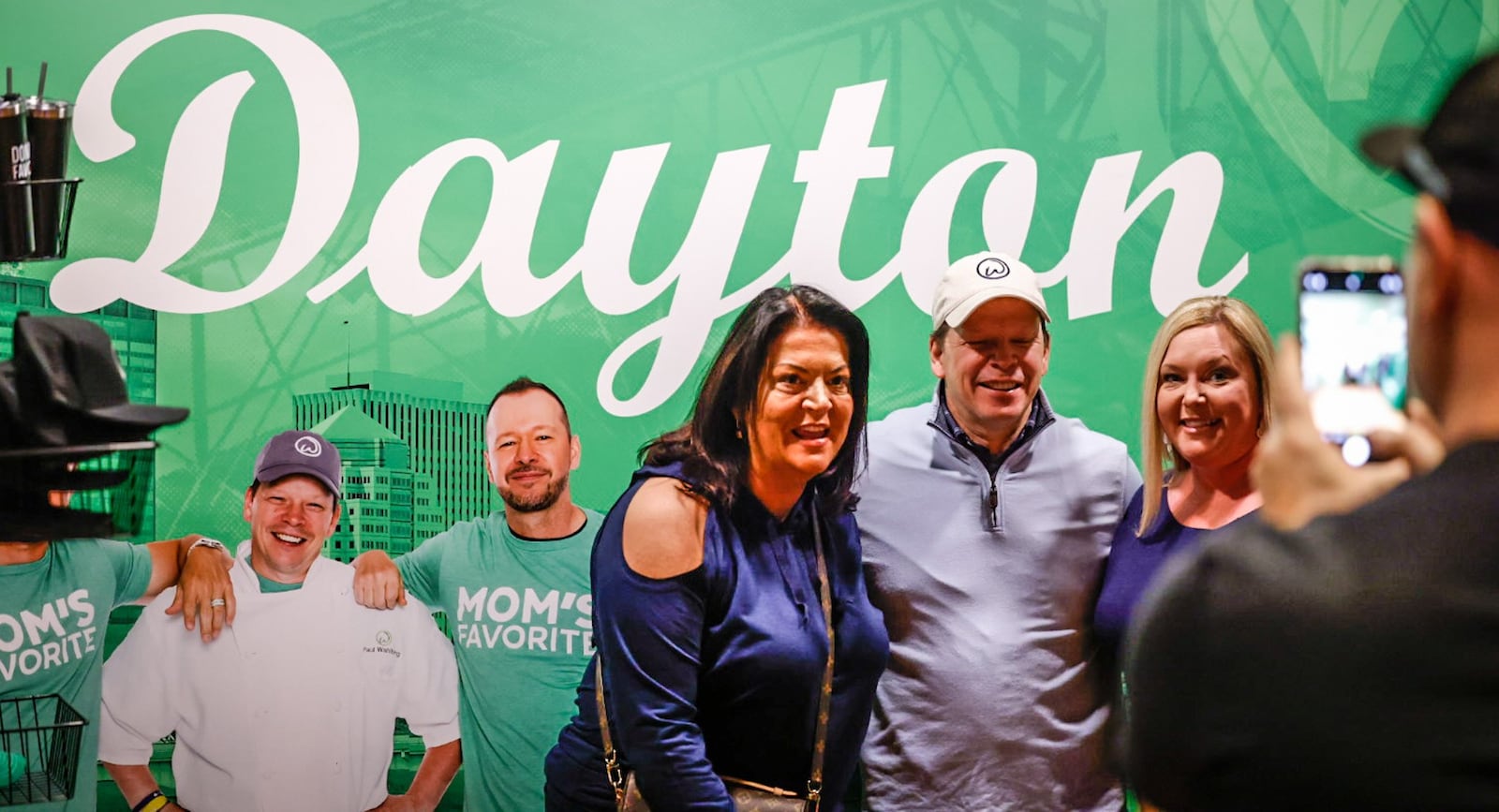 From left, Kelley Grody and Emily Taylor surround Chef Paul Wahlberg for a picture at Hollywood Gaming at Dayton Raceway on Friday January 13, 2023. Wahlberg was in town promoting the opening of Wahlburgers restaurant at Hollywood Gaming. JIM NOELKER/STAFF