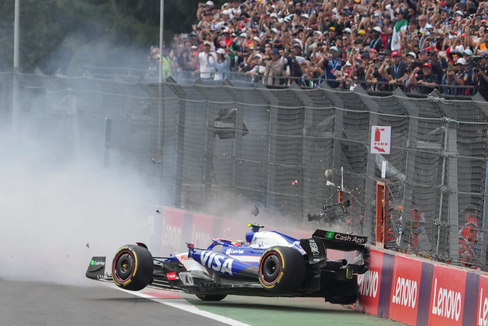 RB driver Yuki Tsunoda of Japan crashes after the start of the Formula One Mexico Grand Prix auto race at the Hermanos Rodriguez racetrack in Mexico City, Sunday, Oct. 27, 2024. (AP Photo/Fernando Llano)