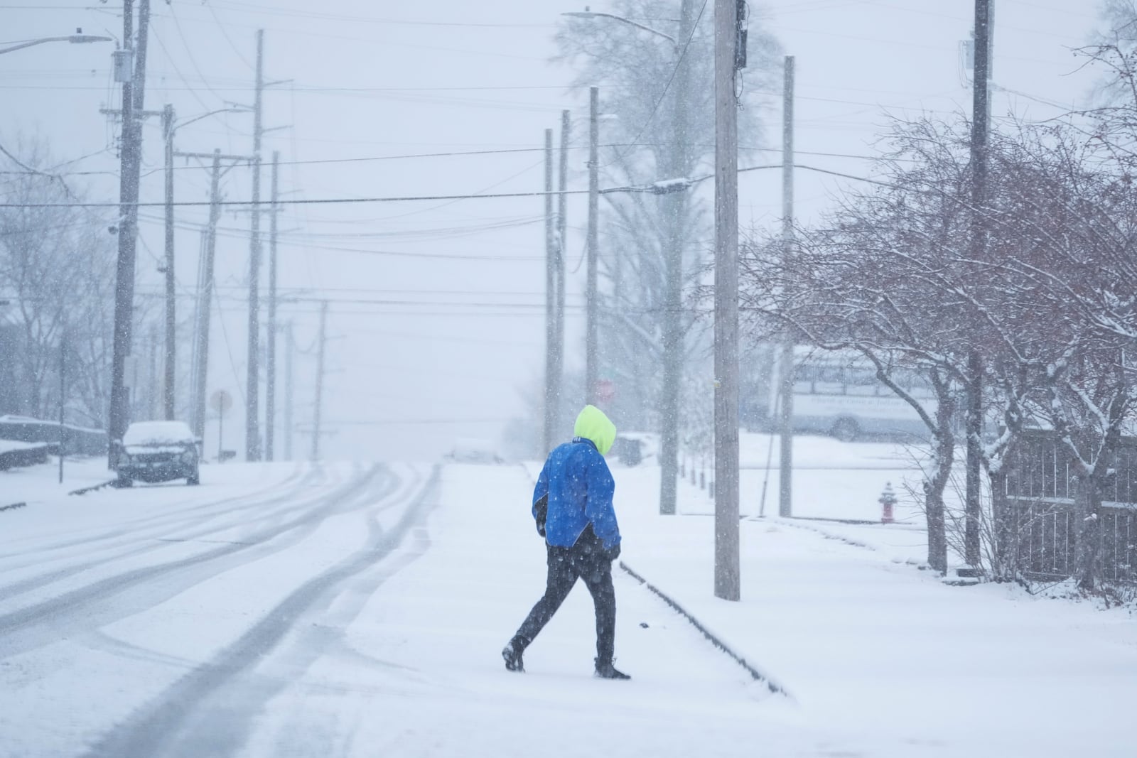 T. Jones walks in the snow Friday, Jan 10, 2025, in Nashville, Tenn. (AP Photo/George Walker IV)