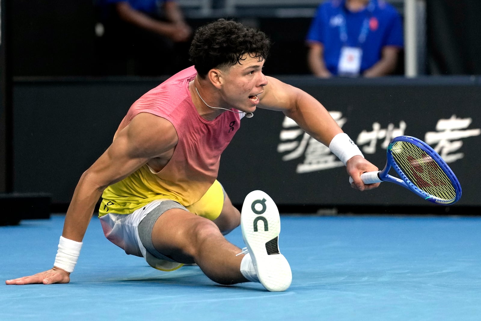 Ben Shelton of the U.S. falls during his third round match against Lorenzo Musetti of Italy at the Australian Open tennis championship in Melbourne, Australia, Saturday, Jan. 18, 2025. (AP Photo/Ng Han Guan)