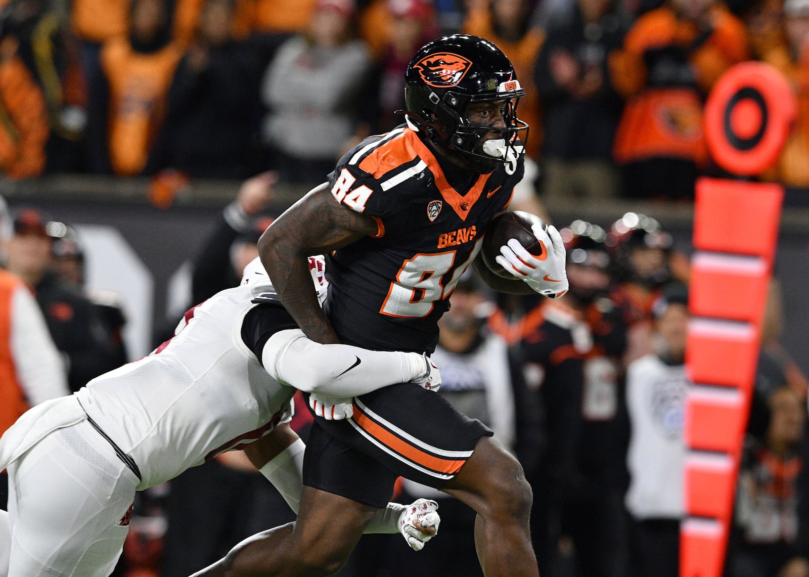 Oregon State tight end Jermaine Terry II (84) pulls Washington State defensive back Kapena Gushiken after a catch during the first half of an NCAA college football game Saturday, Nov. 23, 2024, in Corvallis, Ore. (AP Photo/Mark Ylen)