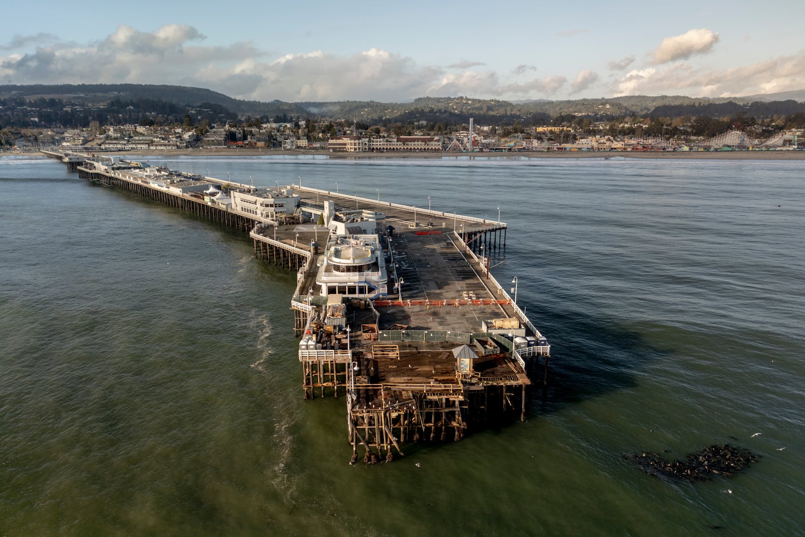 The damaged Santa Cruz Wharf is seen after a section of the pier fell into the ocean during high surf the previous day, in Santa Cruz, Calif., Tuesday, Dec. 24, 2024. (Stephen Lam/San Francisco Chronicle via AP)