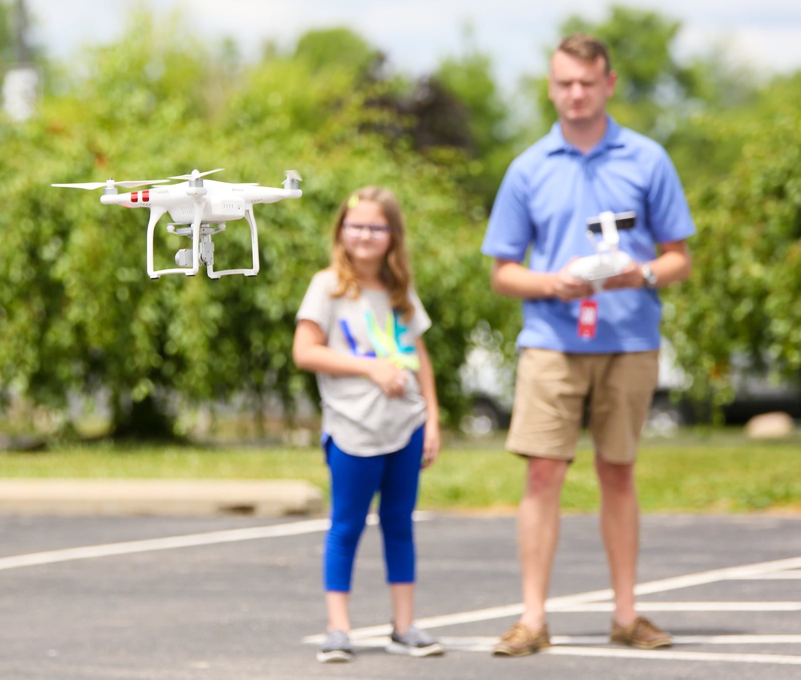 Drone Camp co-founder Matt King works with student Lauren Lacefield, 7, during a summer learning program at Butler Tech, Thursday, June 15, 2017. GREG LYNCH / STAFF