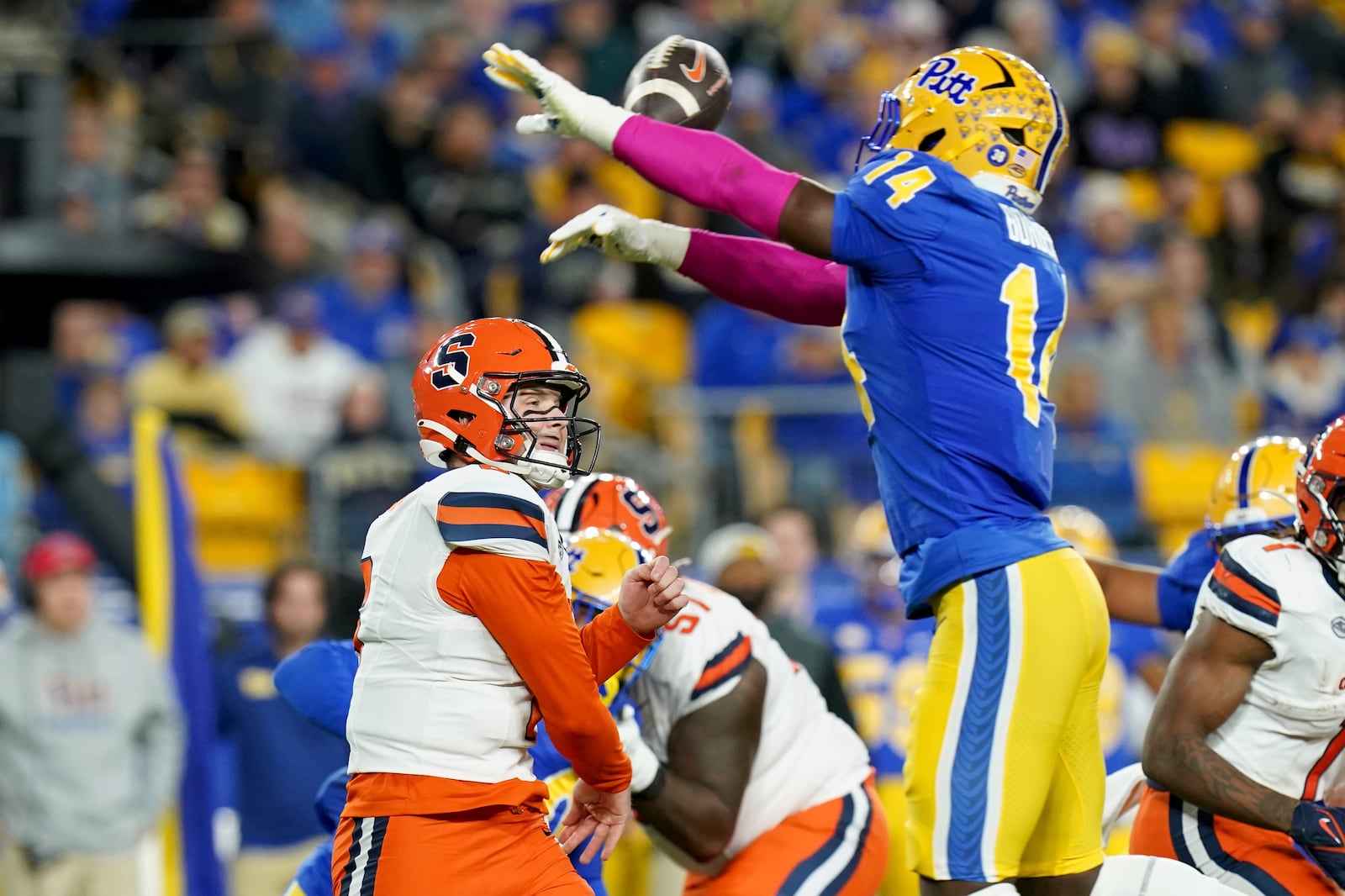 Pittsburgh defensive lineman Chief Borders (14) bats down a pass by Syracuse quarterback Kyle McCord, left, during the first half of an NCAA college football game, Thursday, Oct. 24, 2024, in Pittsburgh. (AP Photo/Matt Freed)