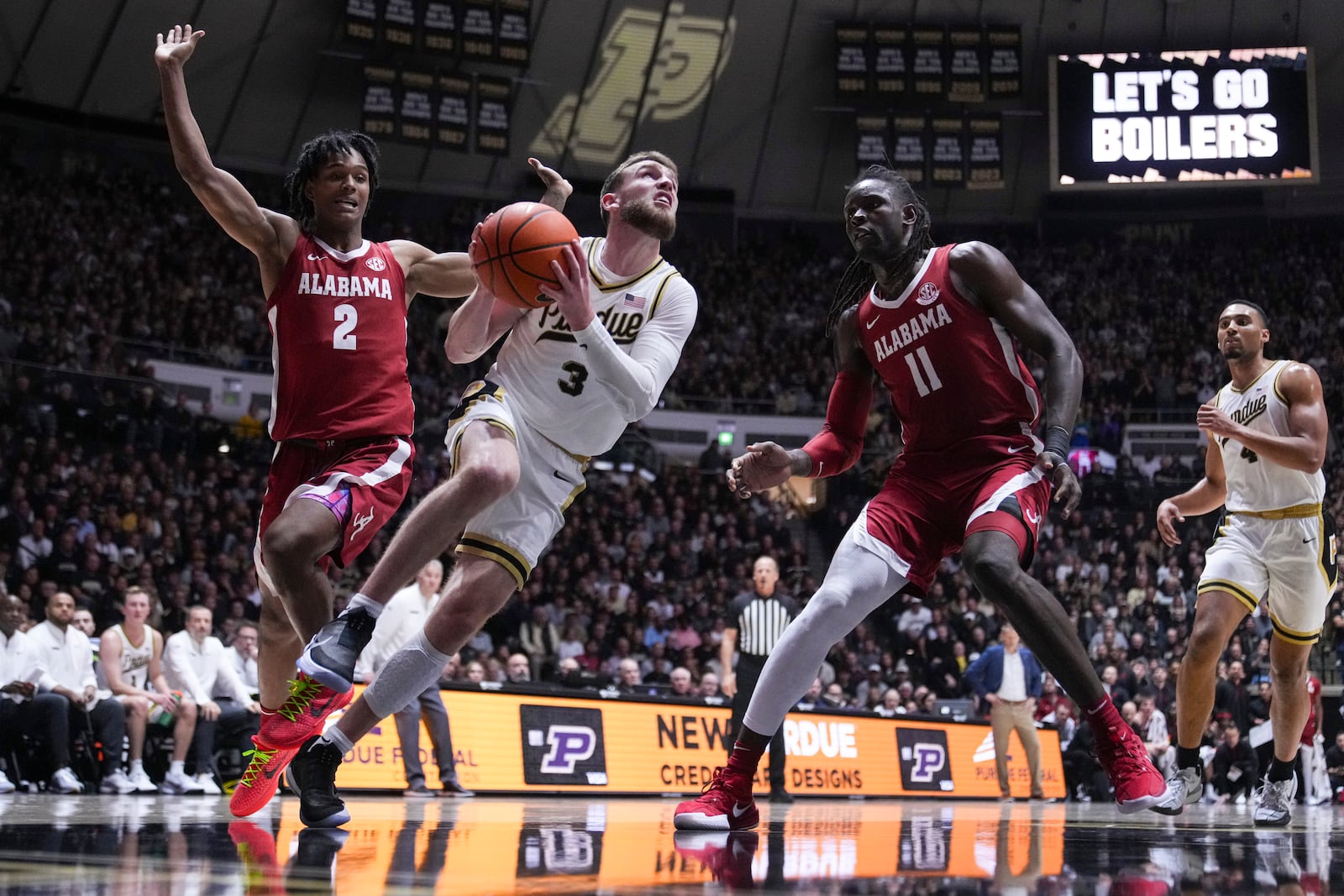 Purdue guard Braden Smith (3) shoots between Alabama guard Aden Holloway (2) and center Clifford Omoruyi (11) during the second half of an NCAA college basketball game in West Lafayette, Ind., Friday, Nov. 15, 2024. (AP Photo/Michael Conroy)