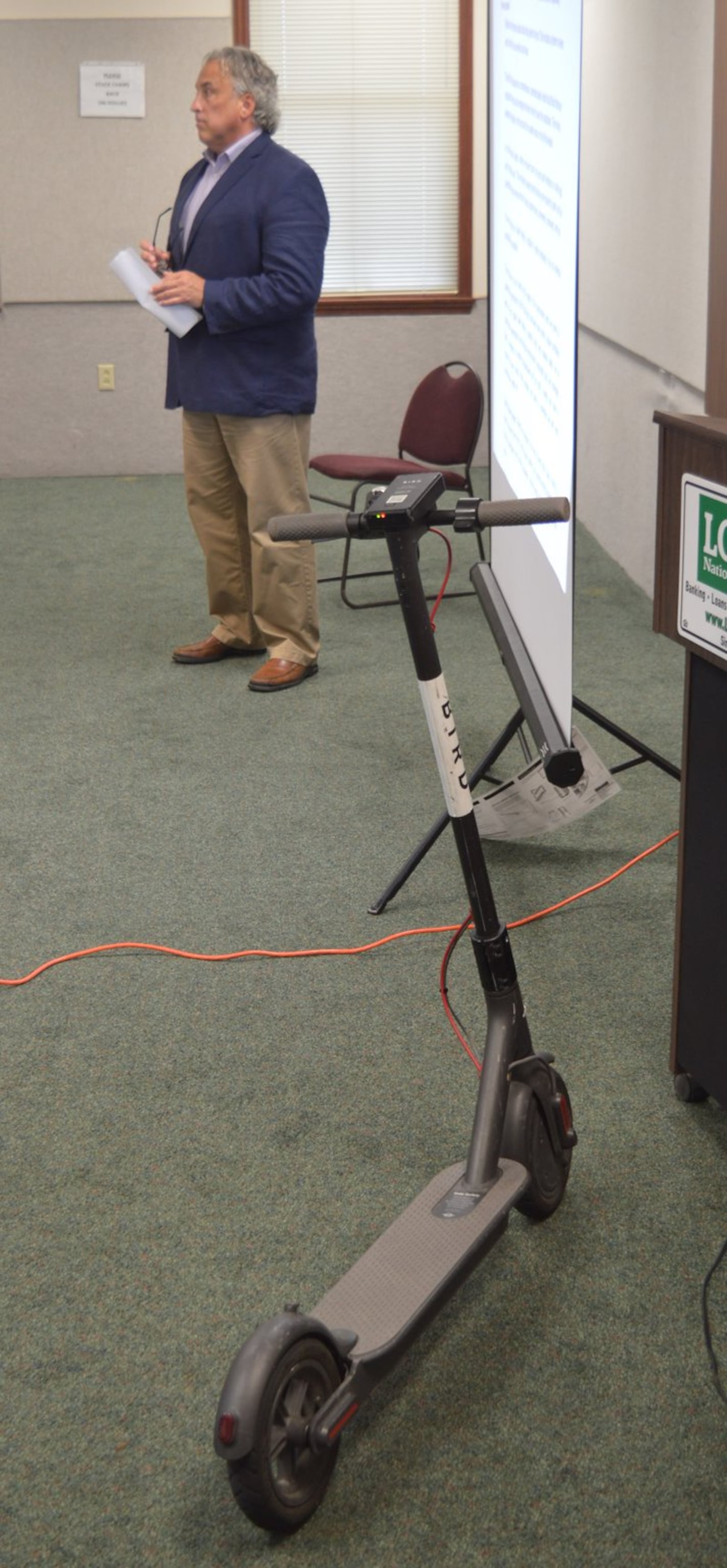 Jeremy Lynch brought one his firm s e-scooters to the presentation Sept. 21 to talk about their plans to bring them to town. 