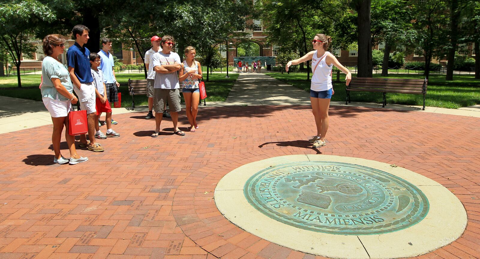 A tour for incoming students around Miami University includes a stop at the university’s seal. 