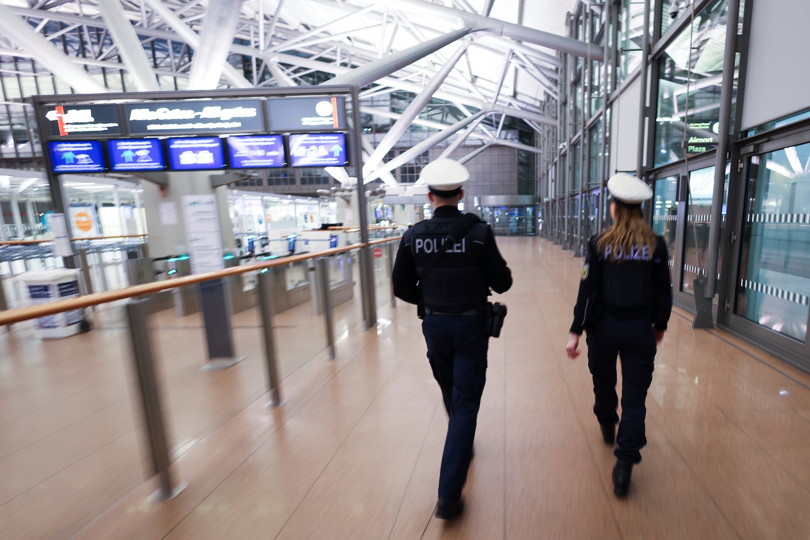 Police patrol along the deserted security checkpoint at Hamburg Airport, Germany Monday, March 10, 2025. (Christian Charisius/dpa/dpa via AP)