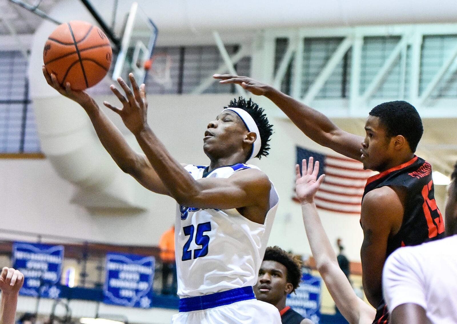 Lakota West’s Myles Greenwood tries to defend a shot by Hamilton’s D’Marco Howard during a game Jan. 5, 2018, at the Hamilton Athletic Center. Host Big Blue won 60-34. NICK GRAHAM/STAFF