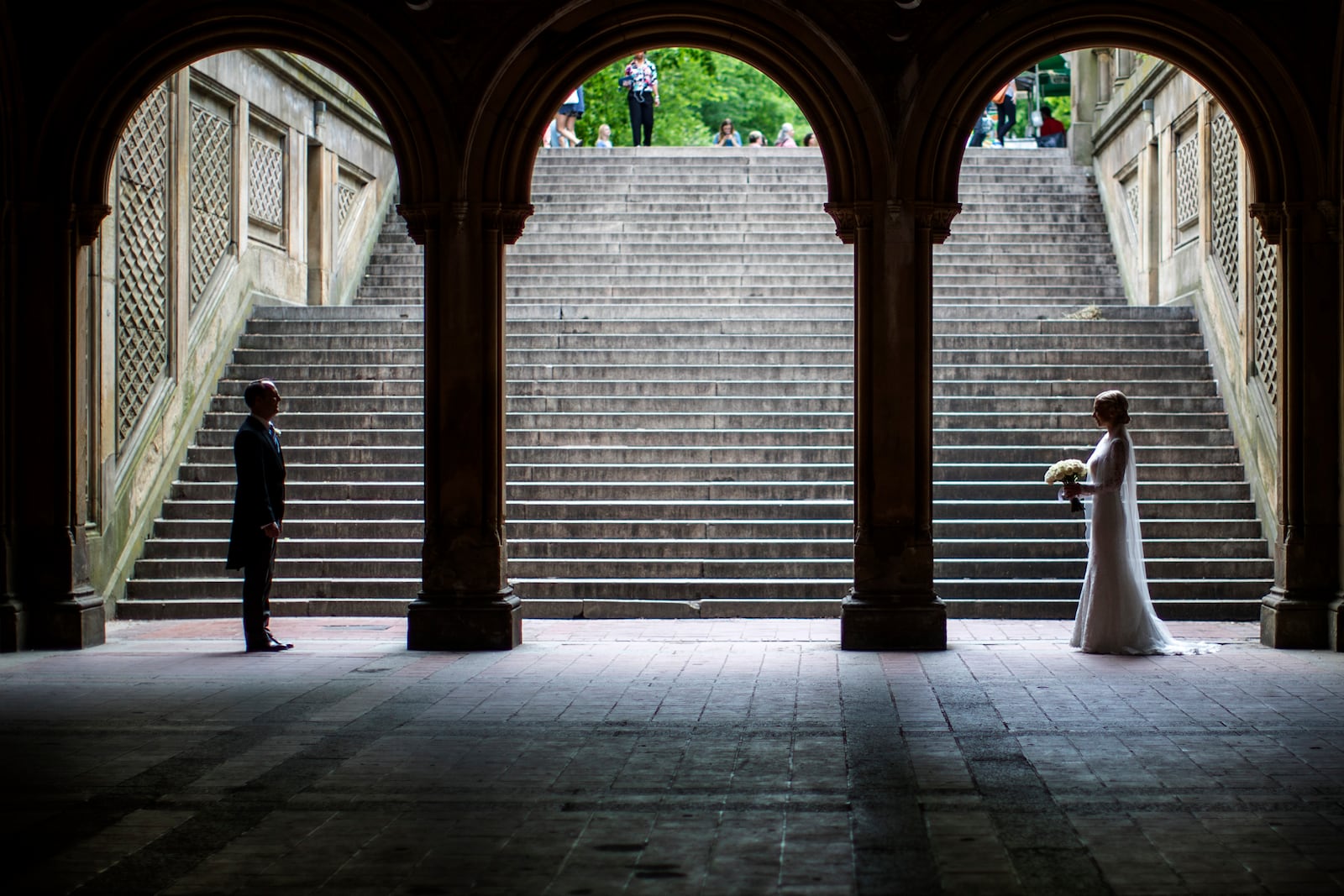 FILE - A bride and groom pose for wedding pictures at the Bethesda Terrace in New York's Central Park on May 23, 2017. (AP Photo/Mary Altaffer, File)