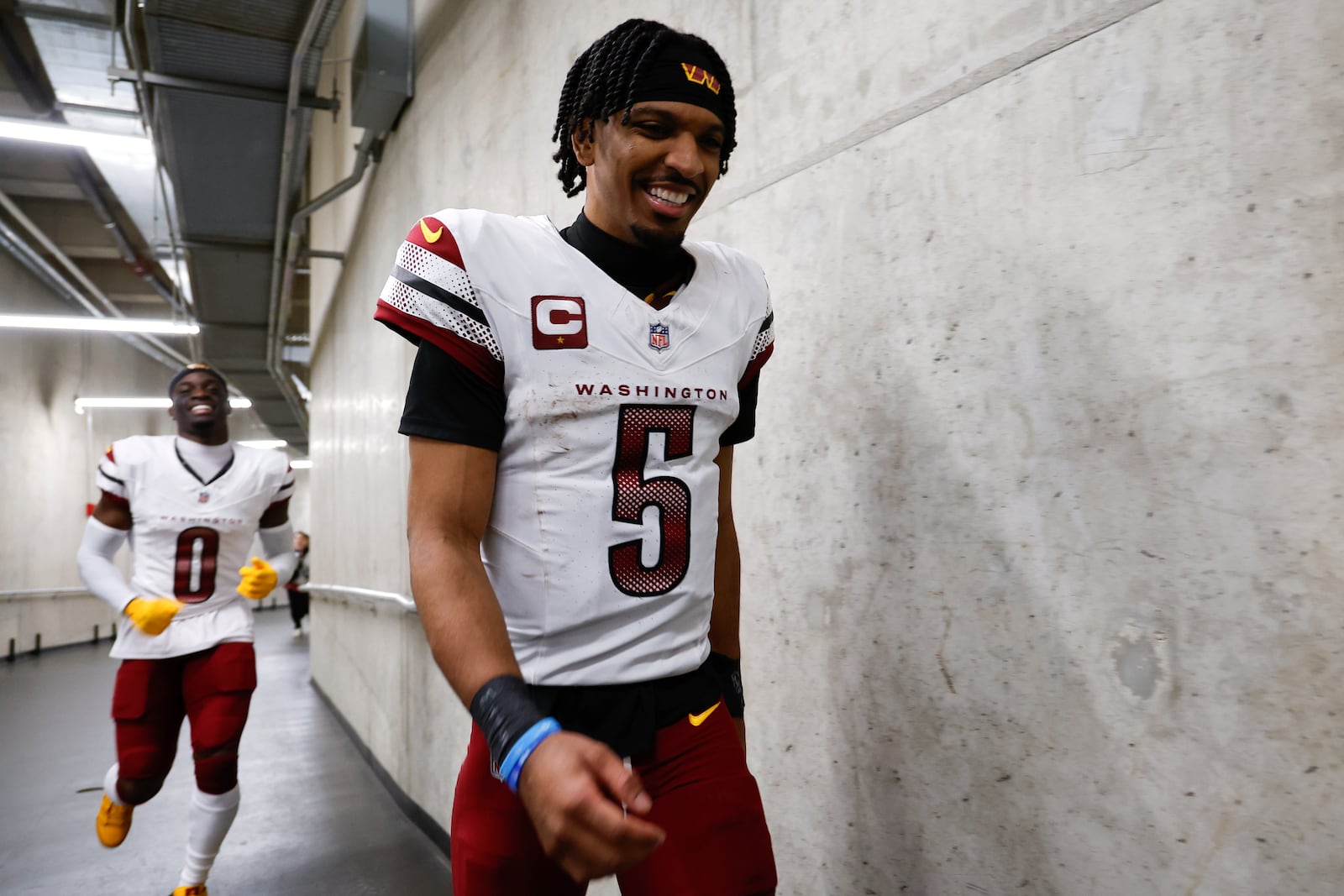 Washington Commanders quarterback Jayden Daniels (5) and Mike Sainristil (0) head to the locker room after an NFL football divisional playoff game against the Detroit Lions, Saturday, Jan. 18, 2025, in Detroit. (AP Photo/Rey Del Rio)