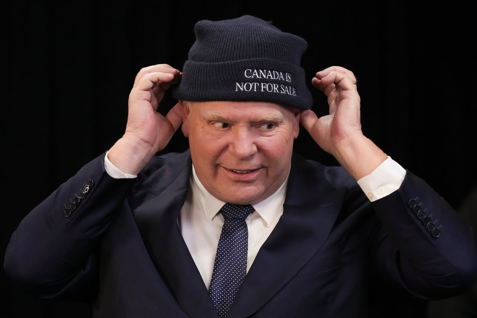 Ontario Premier Doug Ford dons a toque following a press conference with Chief Sonny Gagnon of Aroland First Nation at Queens Park, the provincial legislature, in Toronto, Tuesday, Jan. 28, 2025. (Chris Young/The Canadian Press via AP)