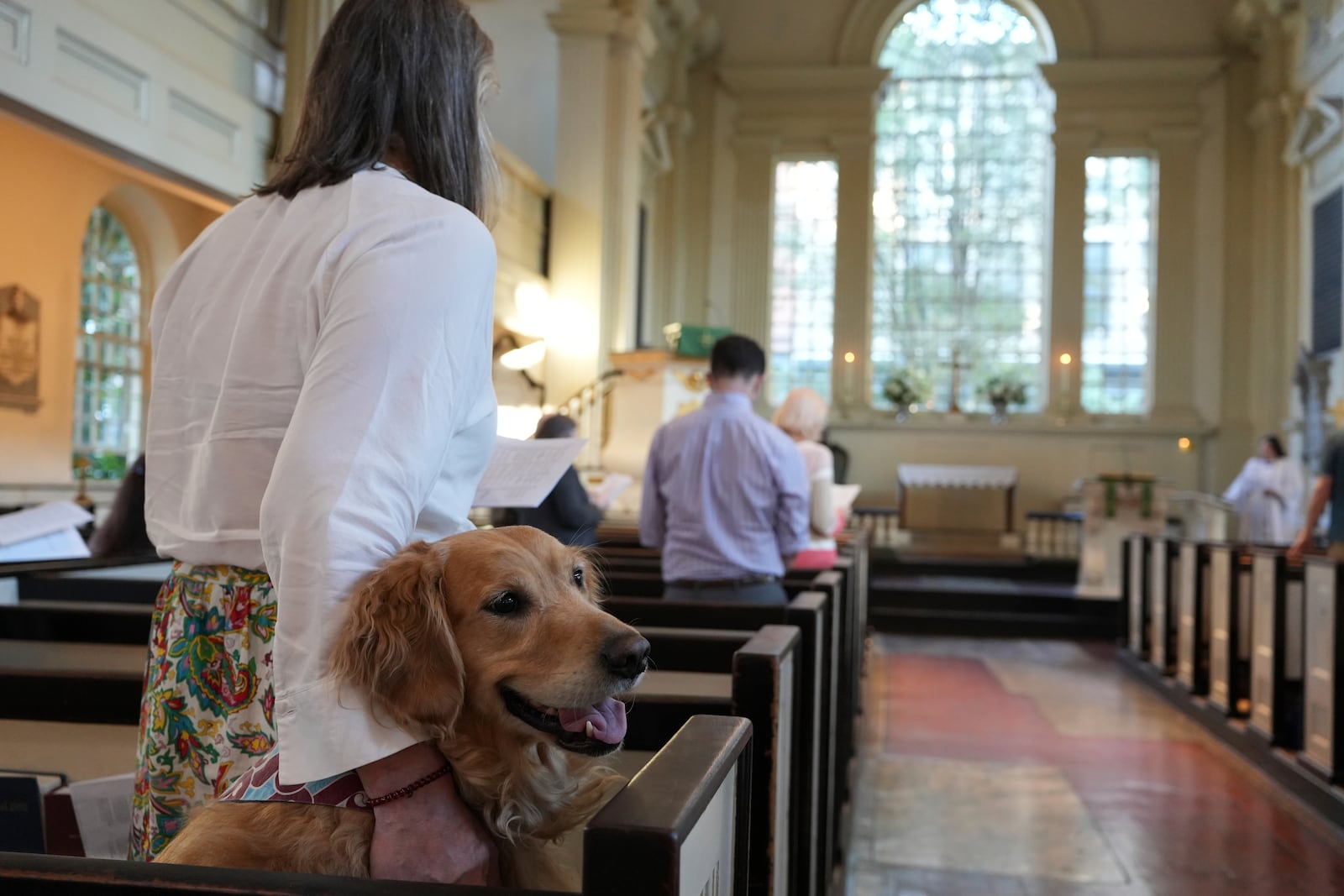 Madeline Tess Farmer and her golden retriever dog, Wrigley, join a Blessing of the Animals ceremony in honor of St. Francis at Philadelphia’s Christ Church on Sunday, Oct. 6, 2024. (AP Photo/Luis Andres Henao)