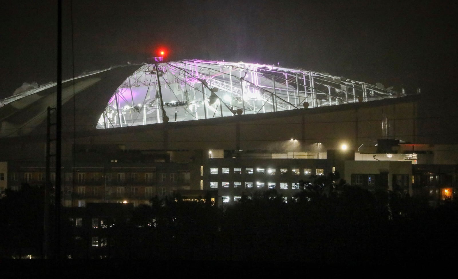 The roof of Tropicana Field, the home of the Tampa Bay Rays, appeared to be badly damaged as Hurricane Milton passes Thursday, Oct. 10, 2024, in St. Petersburg, Fla. (Chris Urso/Tampa Bay Times via AP)