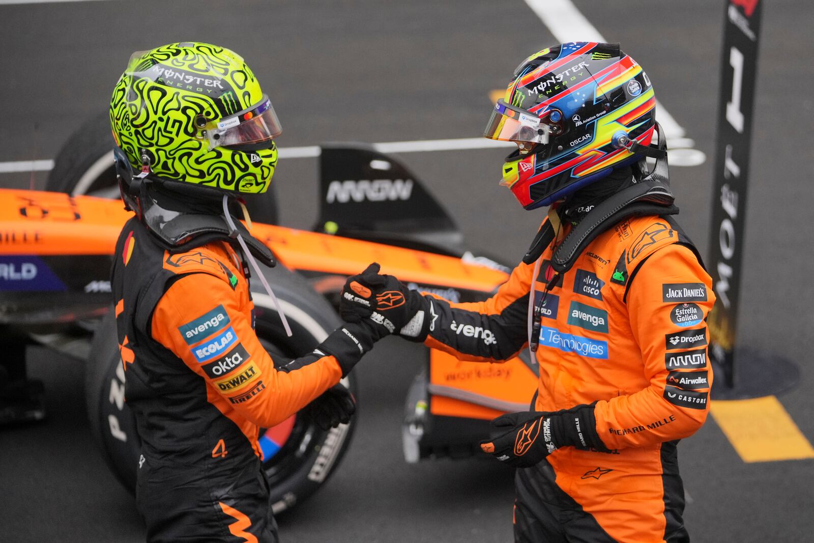 McLaren driver Lando Norris of Britain, left, congratulates McLaren driver Oscar Piastri of Australia for winning the Chinese Formula One Grand Prix race at the Shanghai International Circuit, Shanghai, Sunday, March 23, 2025. (AP Photo/Andy Wong)